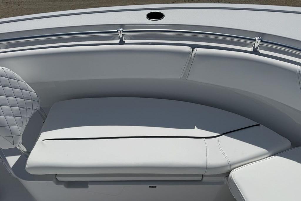 2026 Sportsman Open 252 Center Console boat with cushioned seating area.