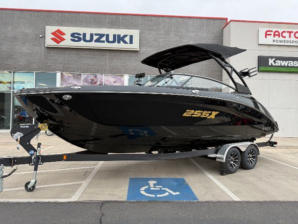 2025 Yamaha Boats 255XD in black, displayed on a trailer outside a dealership.