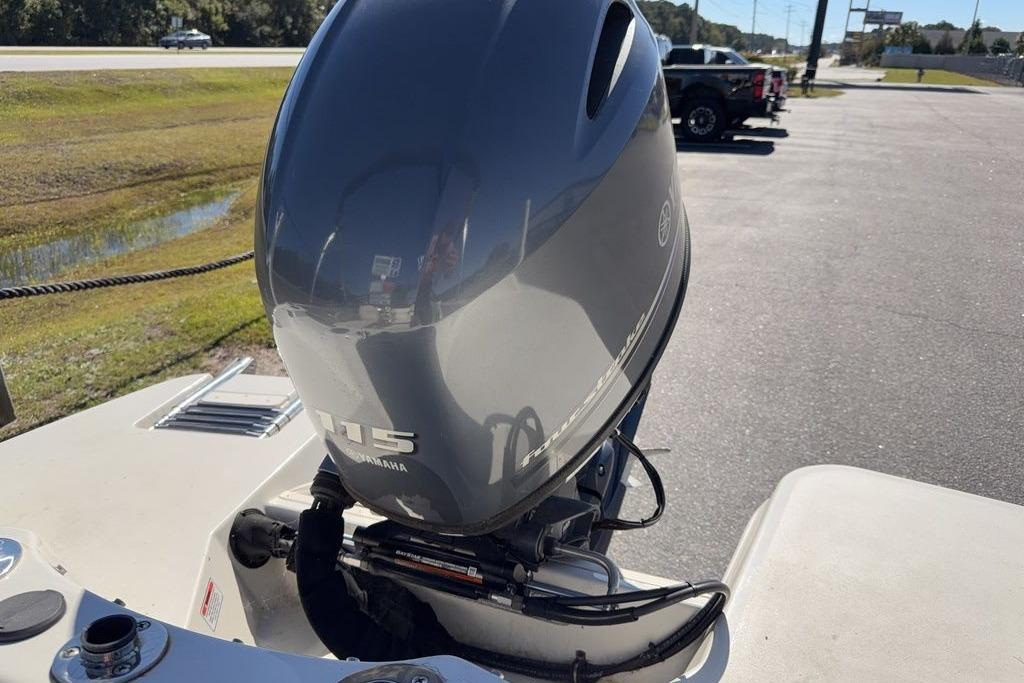 2024 Stingray 191 DC boat with Yamaha 115 outboard motor in parking lot.