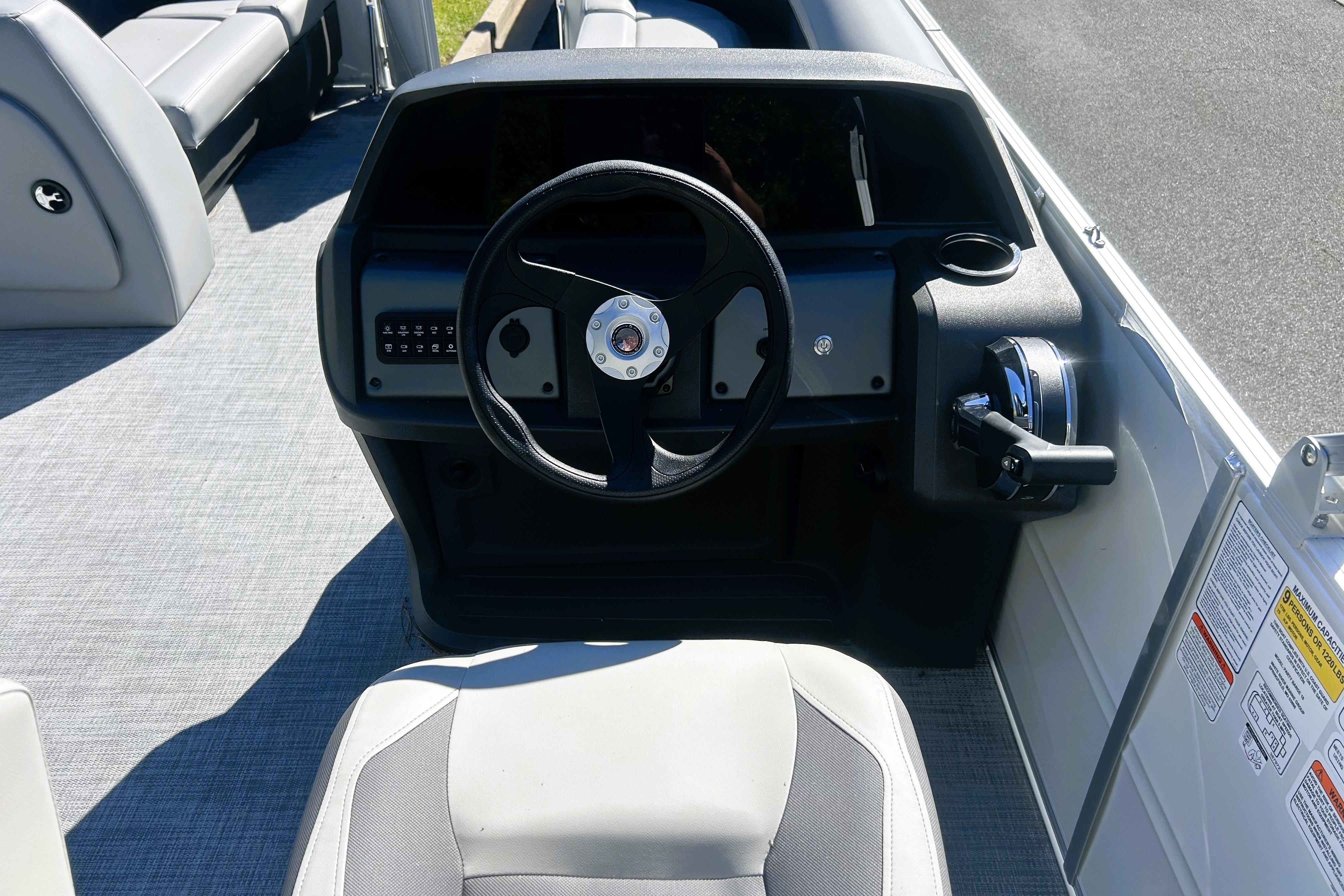 2026 Sun Tracker Party Barge 18 DLX steering console with modern controls and seating.