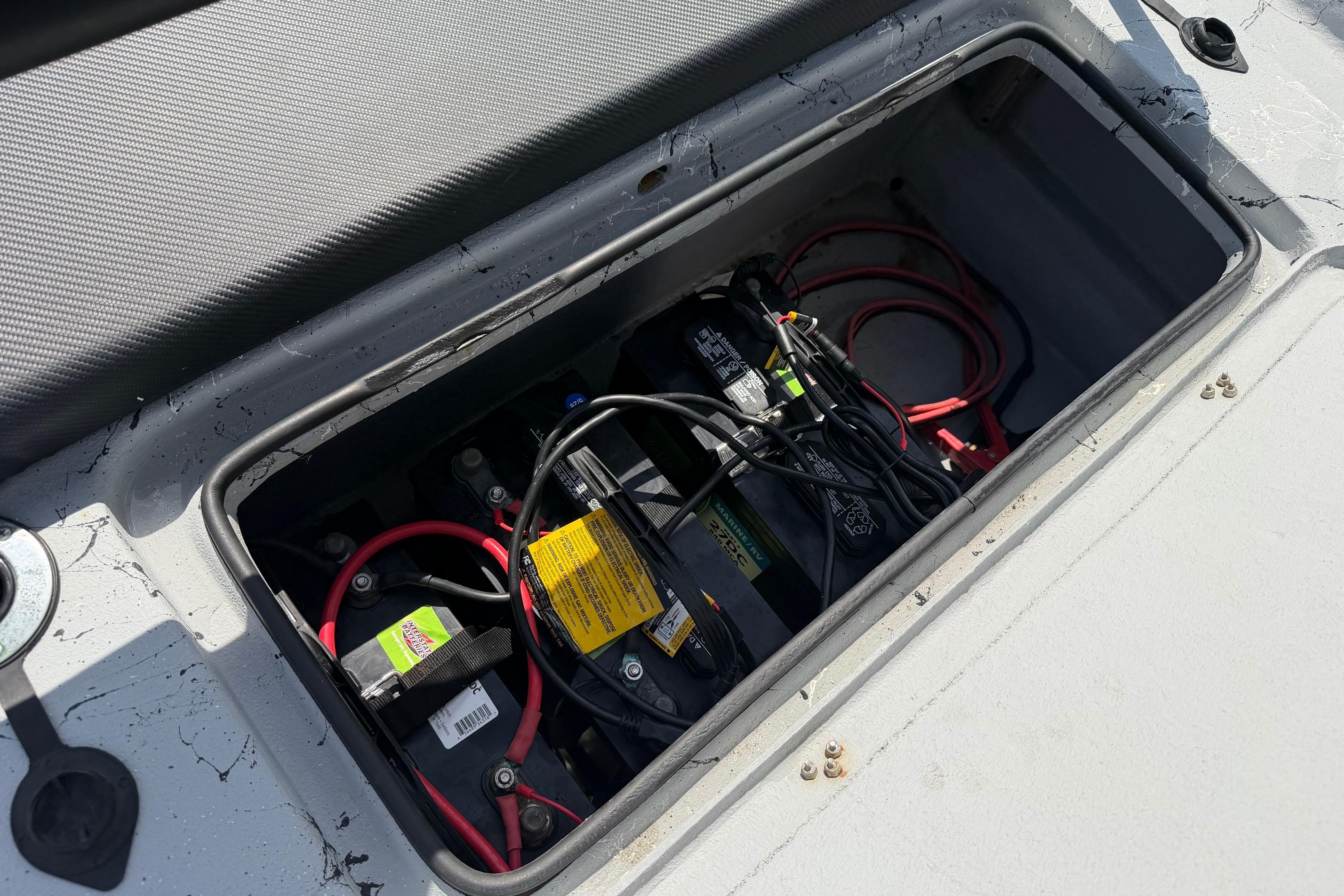 Battery compartment of 2023 Haynie 23 Super Cat boat with wiring and connections.