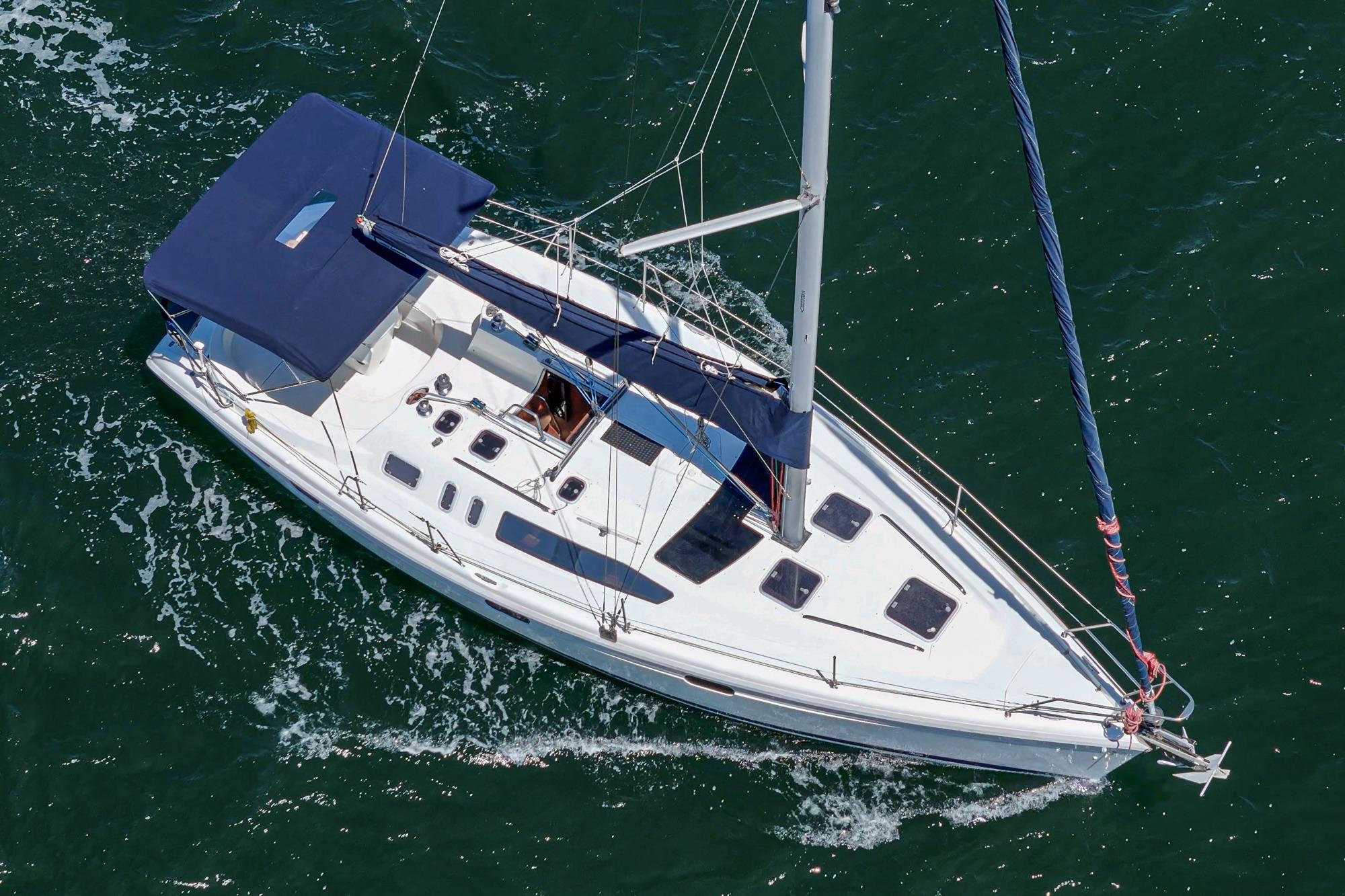 Aerial view of 1996 Hunter 376 sailboat navigating through green waters.