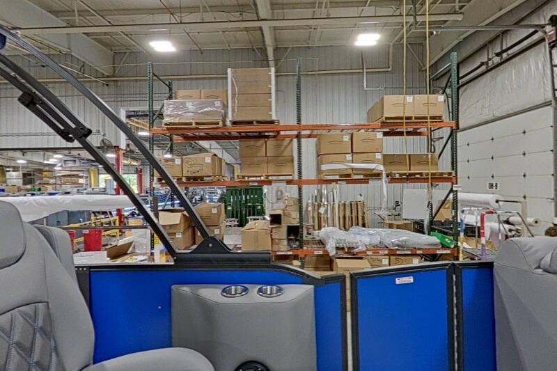 Interior view of a 2026 Bennington 23 LXS Swingback in a warehouse setting.