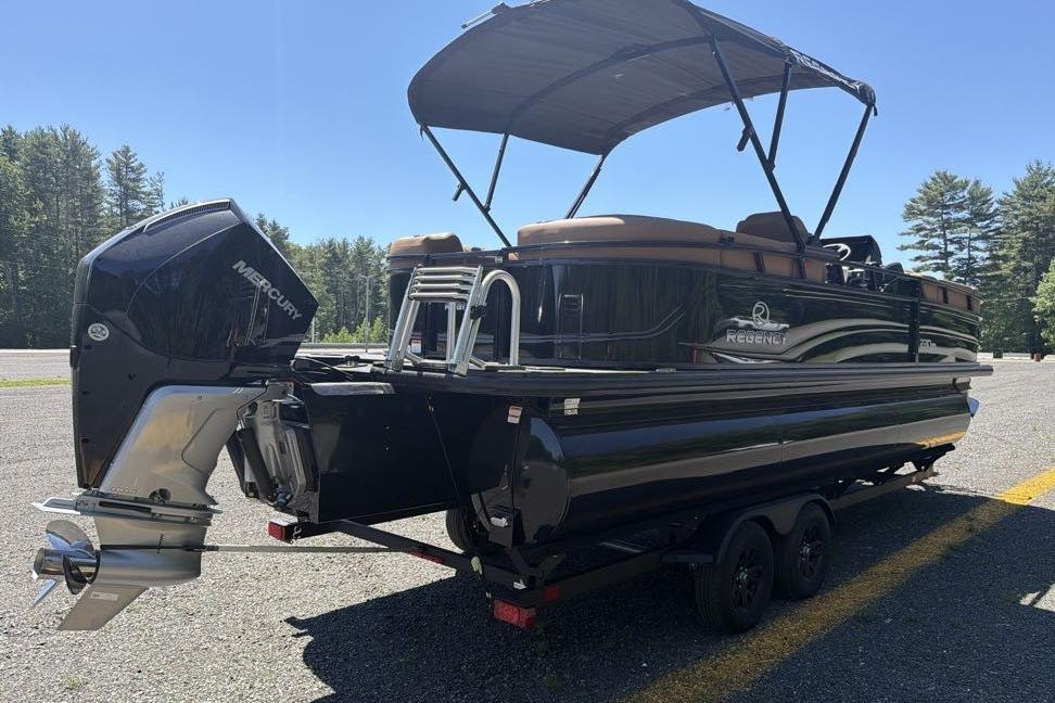 2026 Regency 230 DL pontoon boat with Mercury outboard motor on trailer.