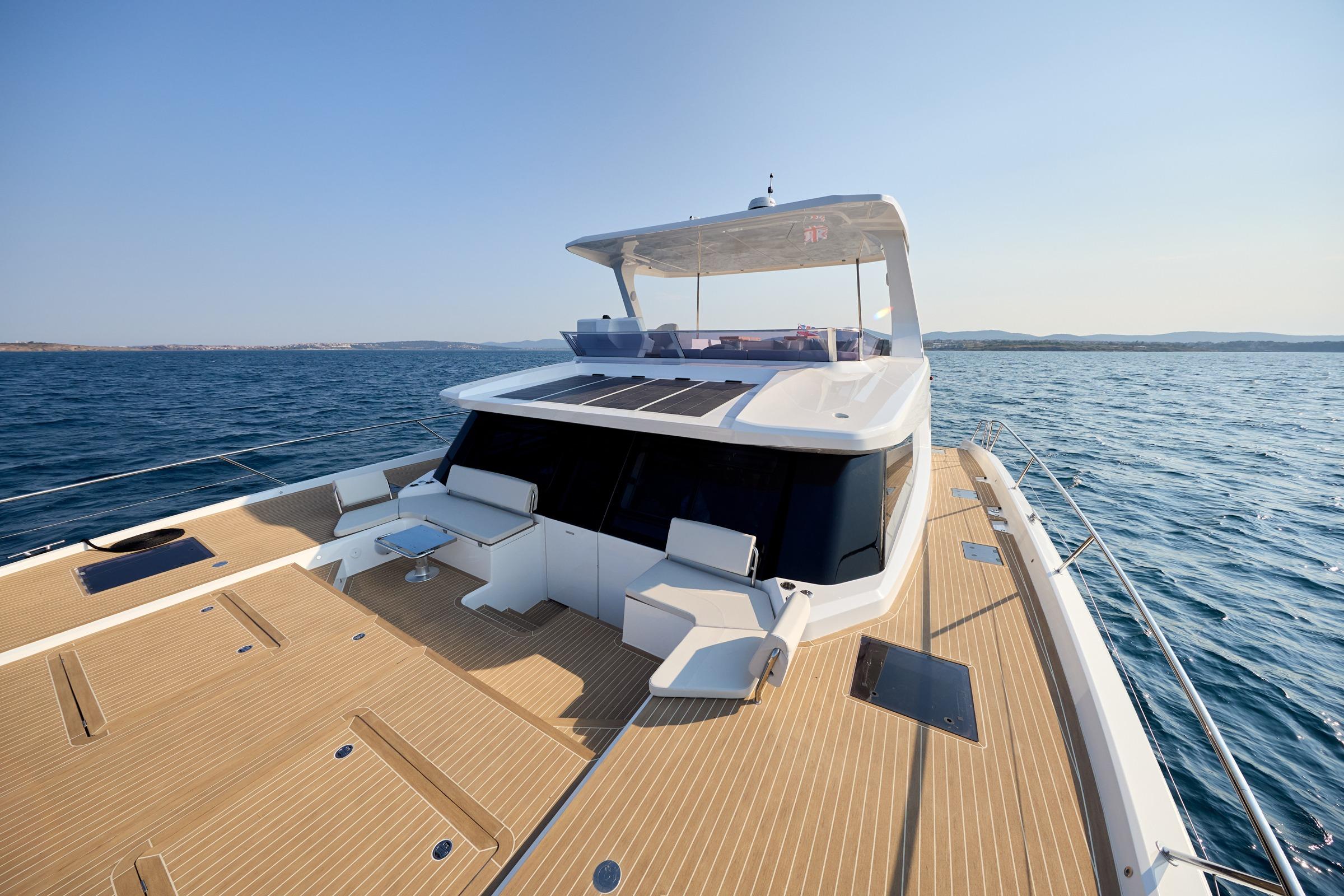 2025 Omaya 50 Power Catamaran cruising on open sea with spacious deck and modern design.
