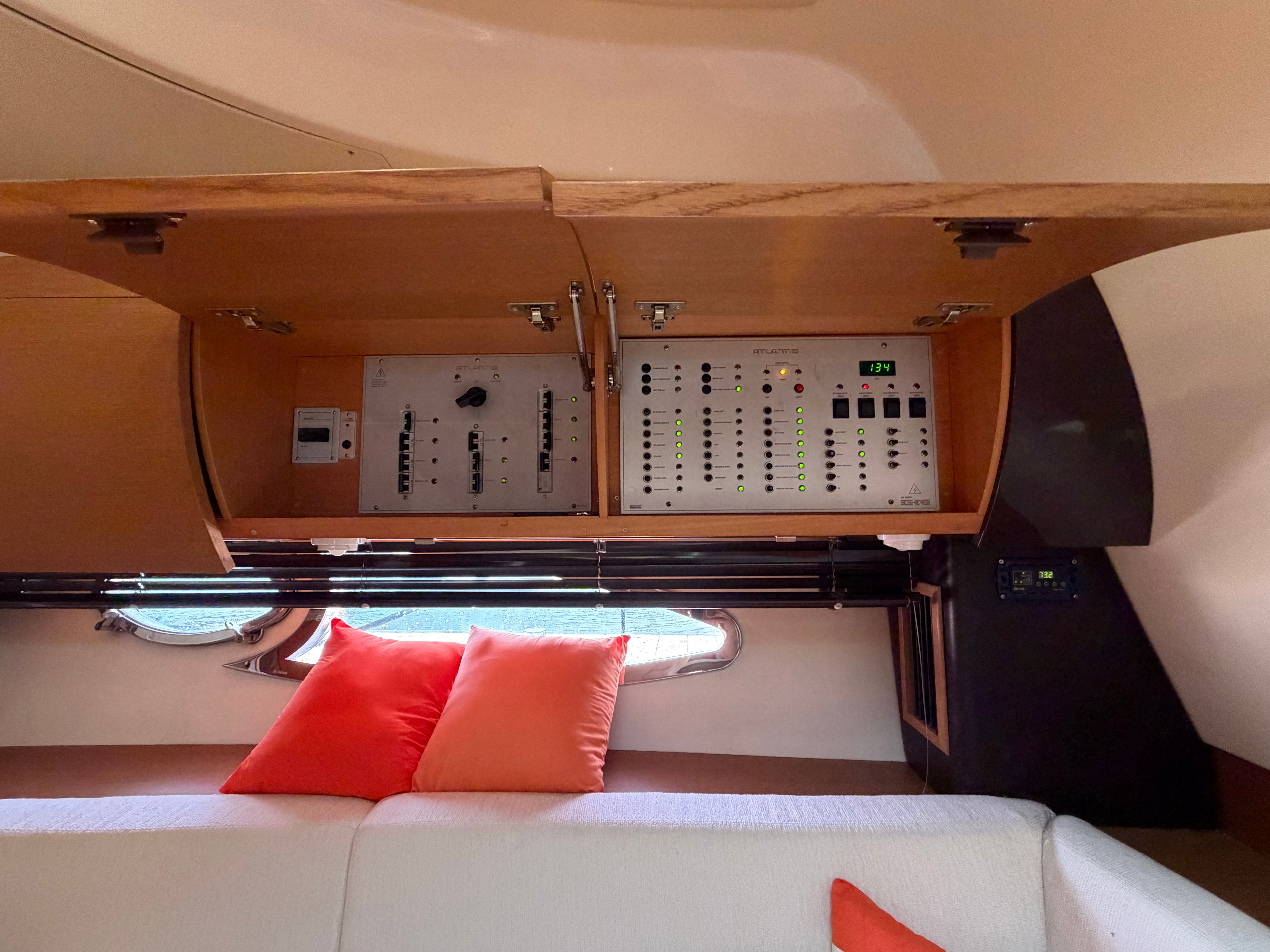 Electrical panel in the cabin of a 2011 Azimut Atlantis 40, with orange cushions.