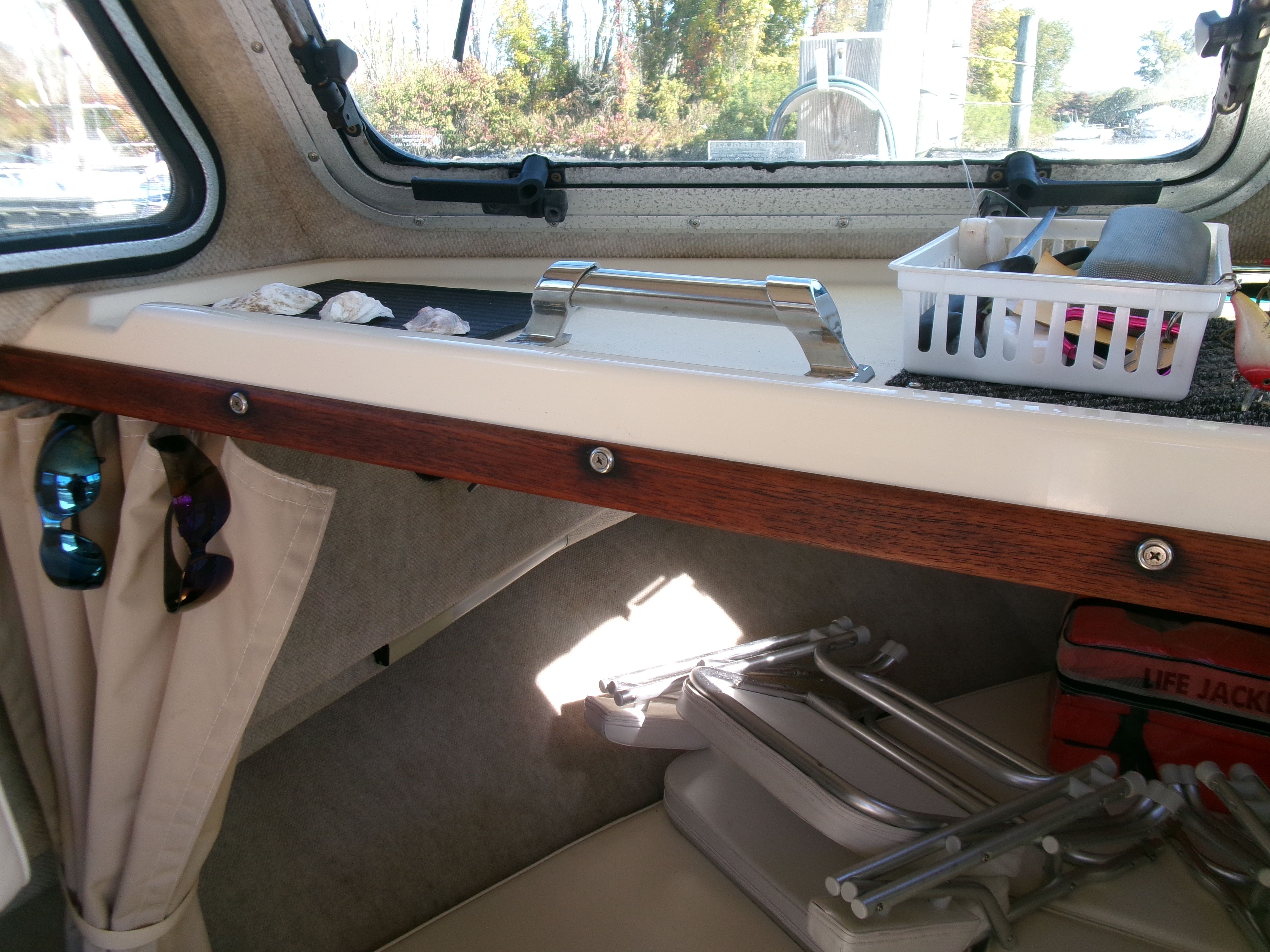 Interior of a 2007 Parker 2520 XL Sport Cabin with shelf and life jacket.