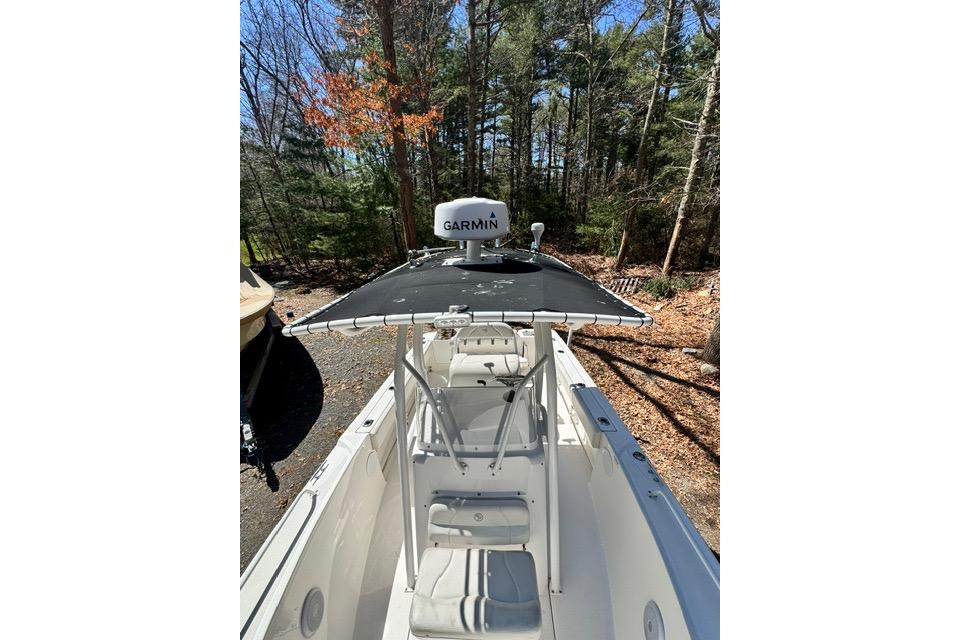 2021 Edgewater 208CC boat with Garmin equipment, parked in a wooded area.