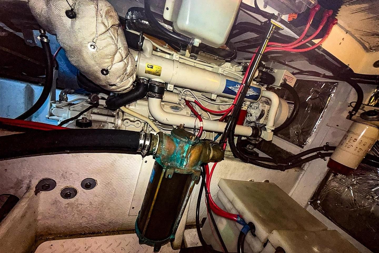 Engine room of 2002 Bayliner 3988 Command Bridge Motoryacht, showcasing mechanical components and wiring.