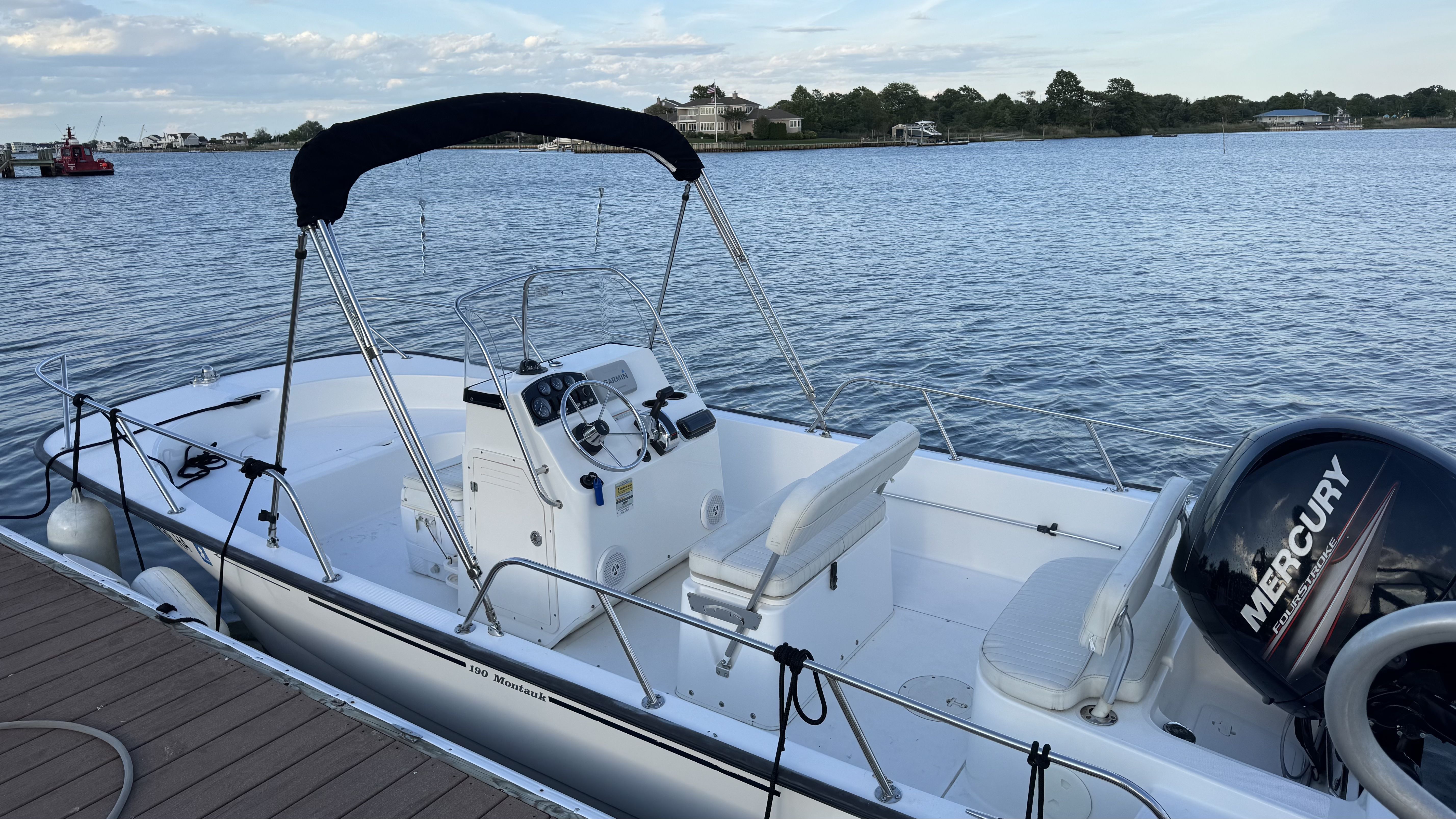 2007 Boston Whaler 190 Montauk boat docked with Mercury engine.