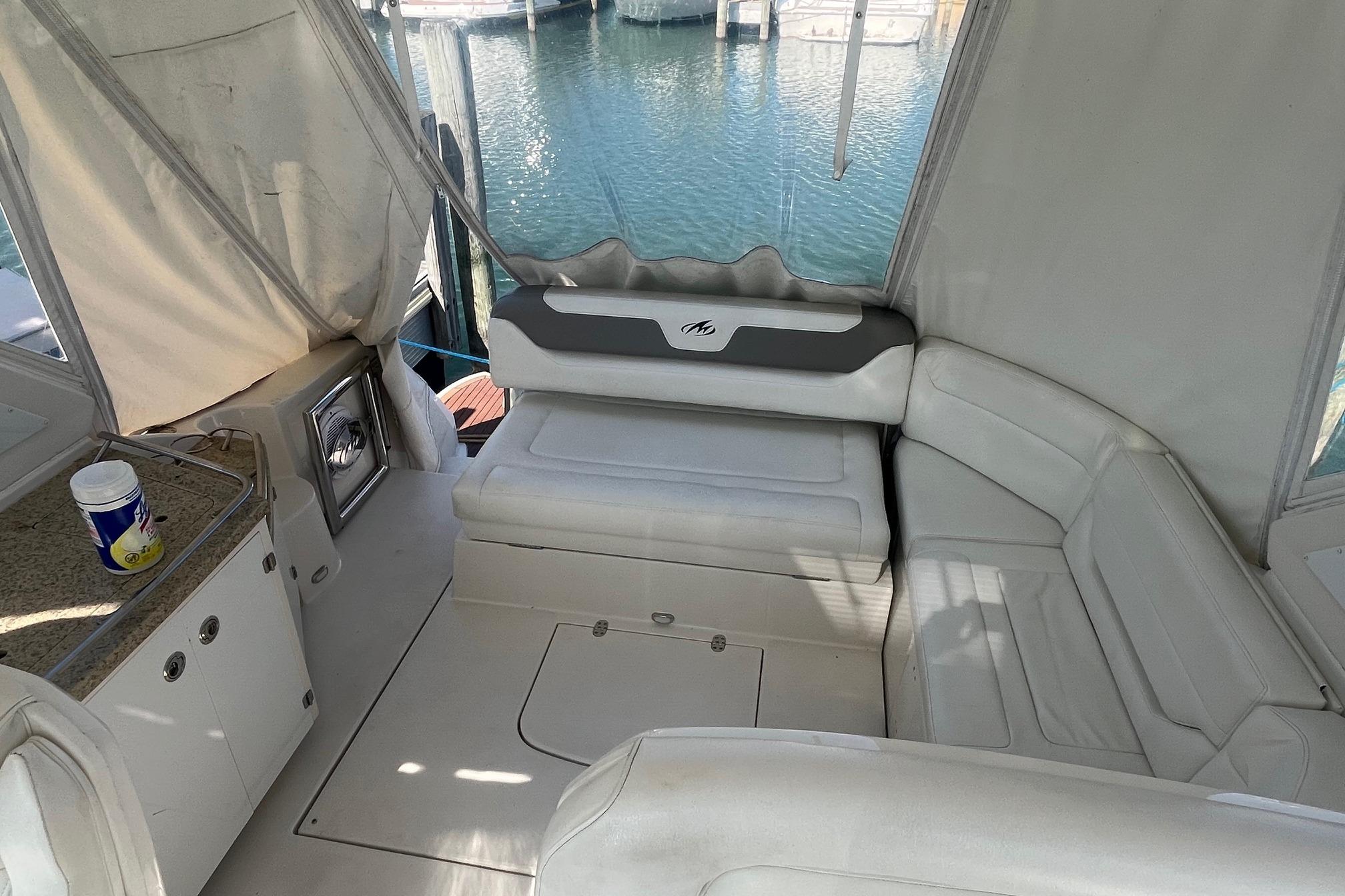 Interior of 2010 Monterey 400 Sport Yacht with white seating and water view.