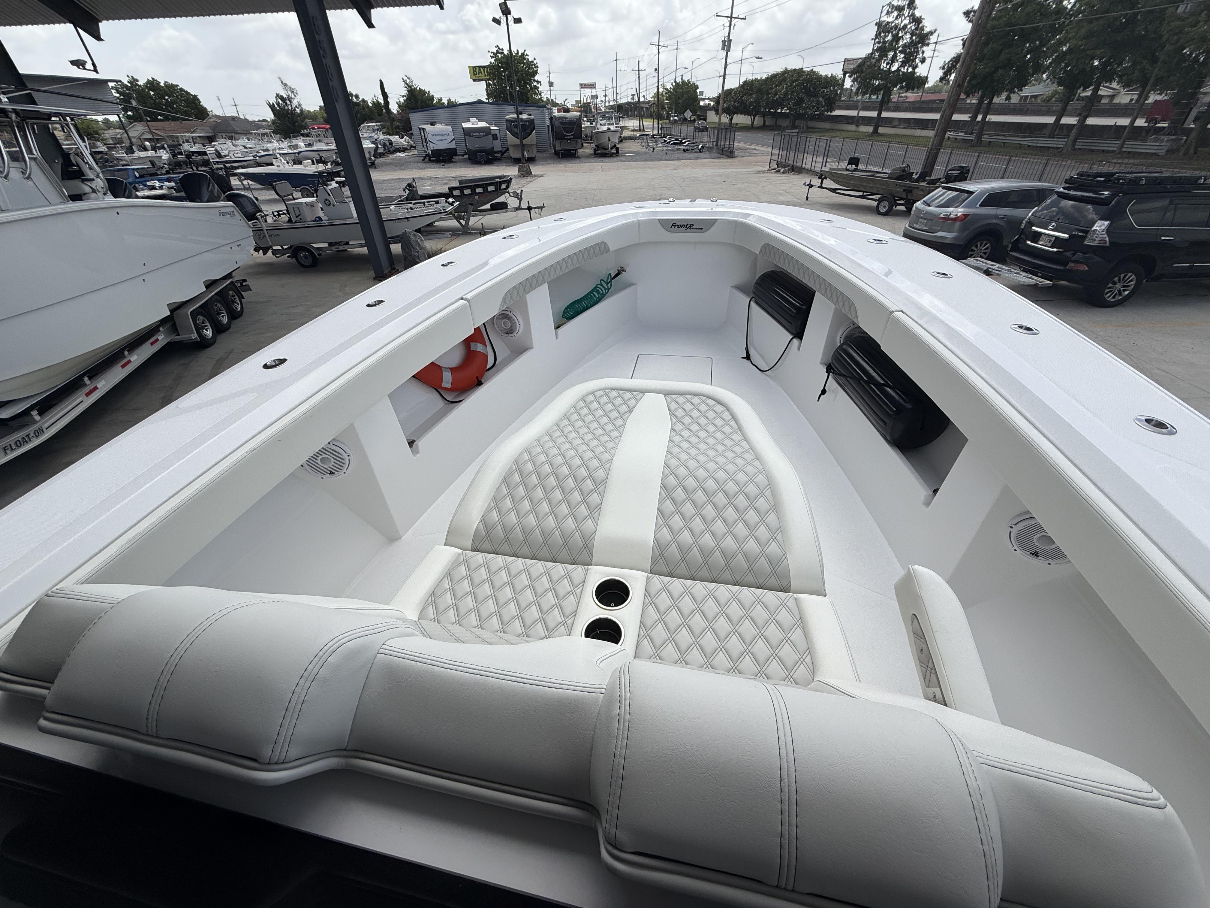 2024 Front Runner 39 CC boat interior with luxurious white seating and cup holders.