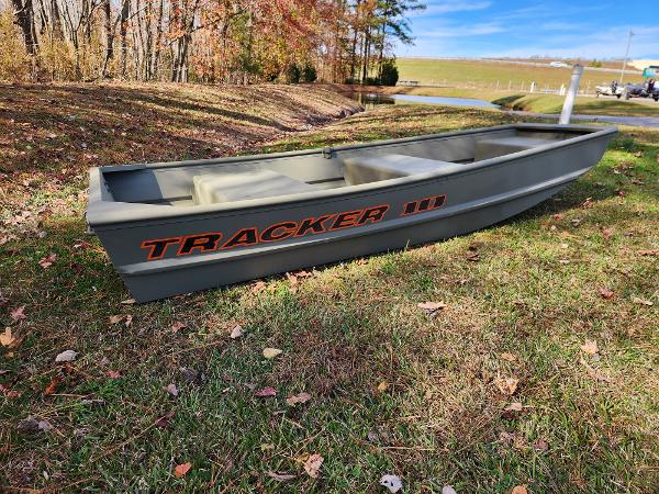 2025 Tracker Grizzly 1036 Utility boat on grassy field, autumn trees in background.