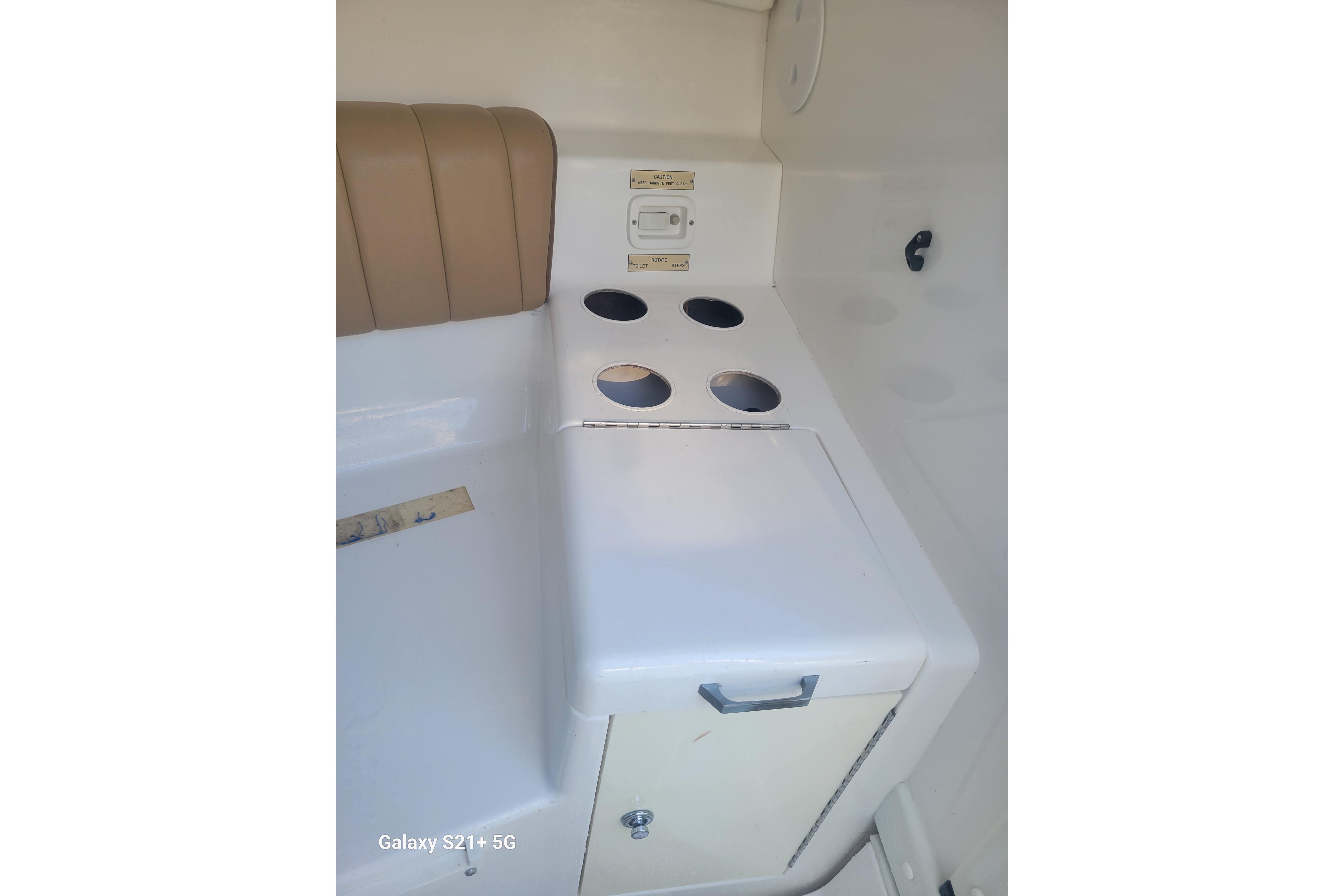 Interior of 2005 Intrepid 323 Cuddy boat with seating and storage.
