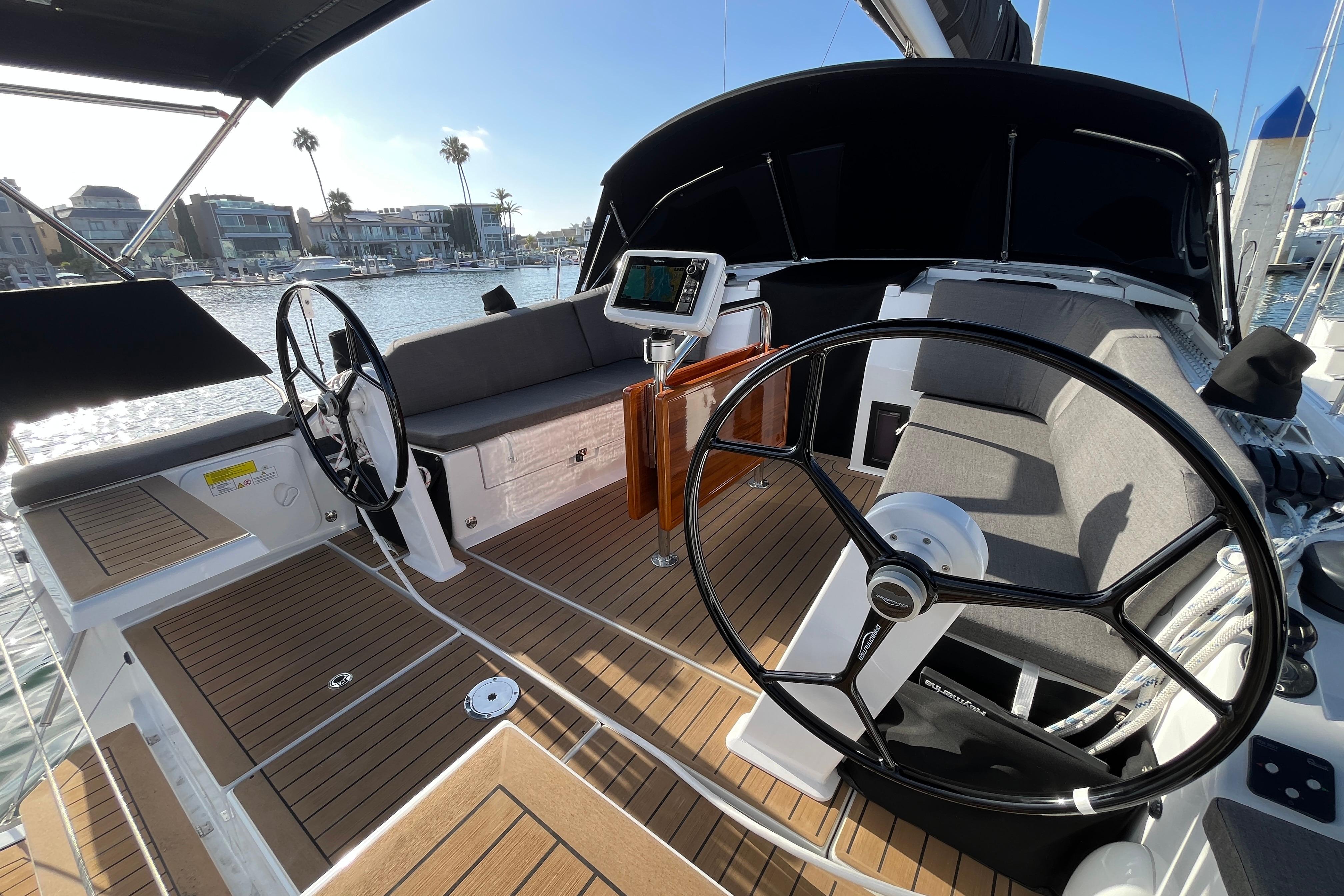 Modern 2025 Hanse 360 yacht cockpit with dual steering wheels and sleek design.