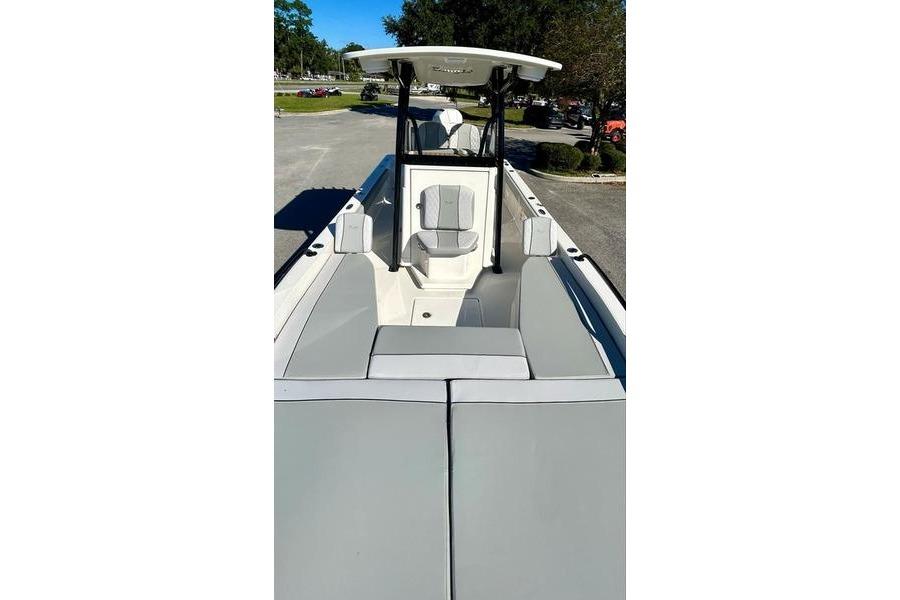 2026 Ranger 2360 Bay boat interior with seating and console, parked outdoors.
