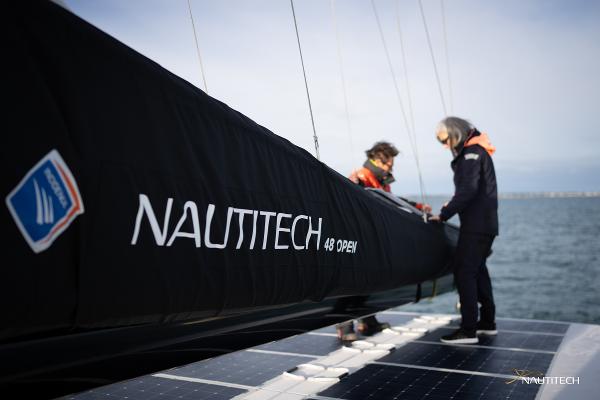 2025 Nautitech 48 Open catamaran with crew on deck, featuring sleek design and branding.