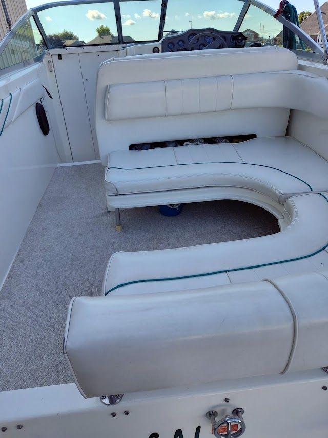 Interior of a 1994 Sea Ray 230 Sundancer with white seating.