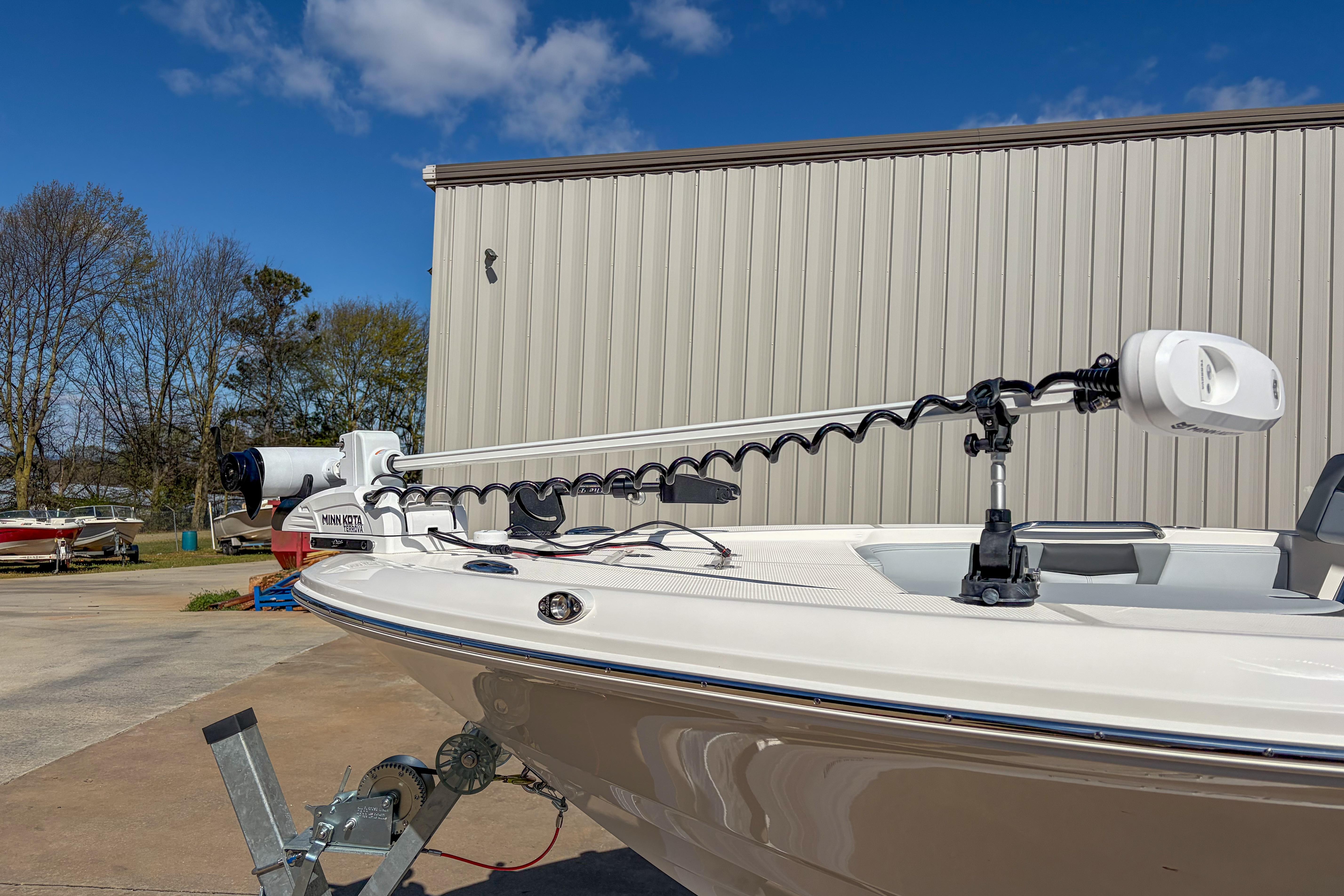2025 Robalo 226 Cayman boat with Minn Kota trolling motor, parked outdoors.