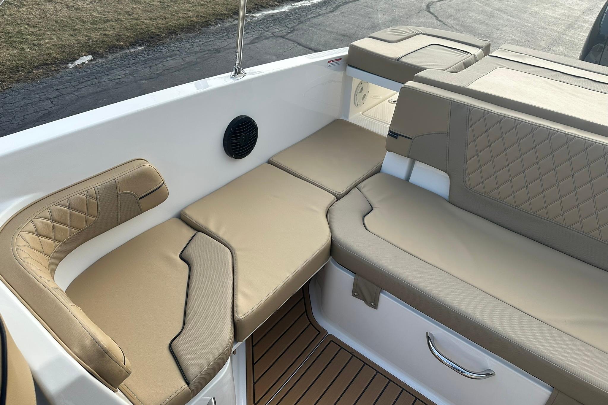 2026 Bayliner VR6 Bowrider OB interior with beige cushioned seating and sleek design.