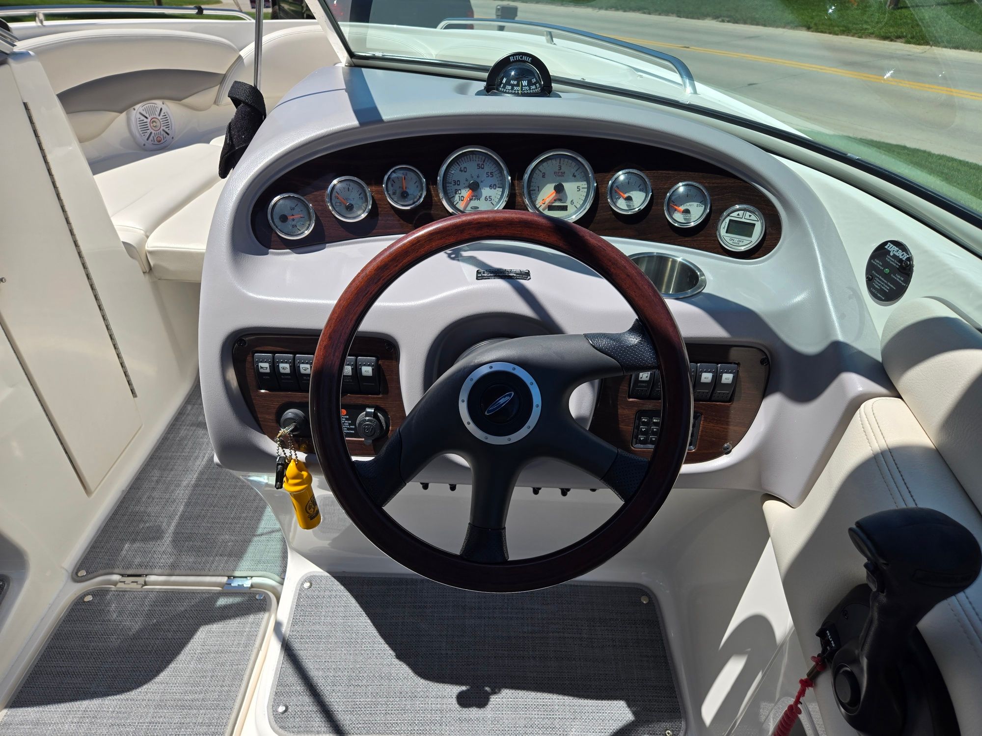 The image shows the cockpit of a 2005 Chaparral 220 SSi with a sleek wood steering wheel.