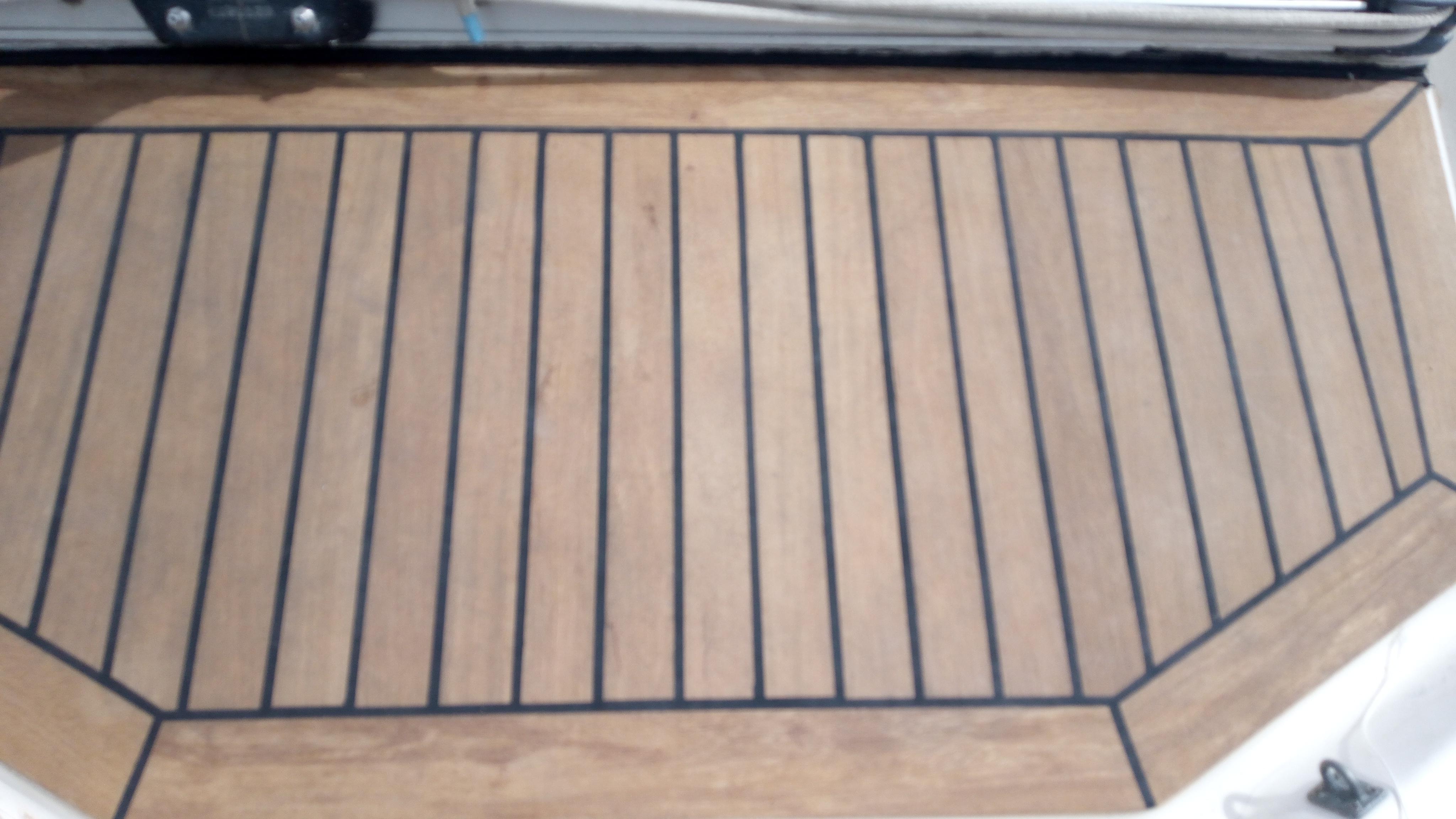 Teak deck of 1977 Nautor Swan 411 sailboat, featuring classic wood paneling.
