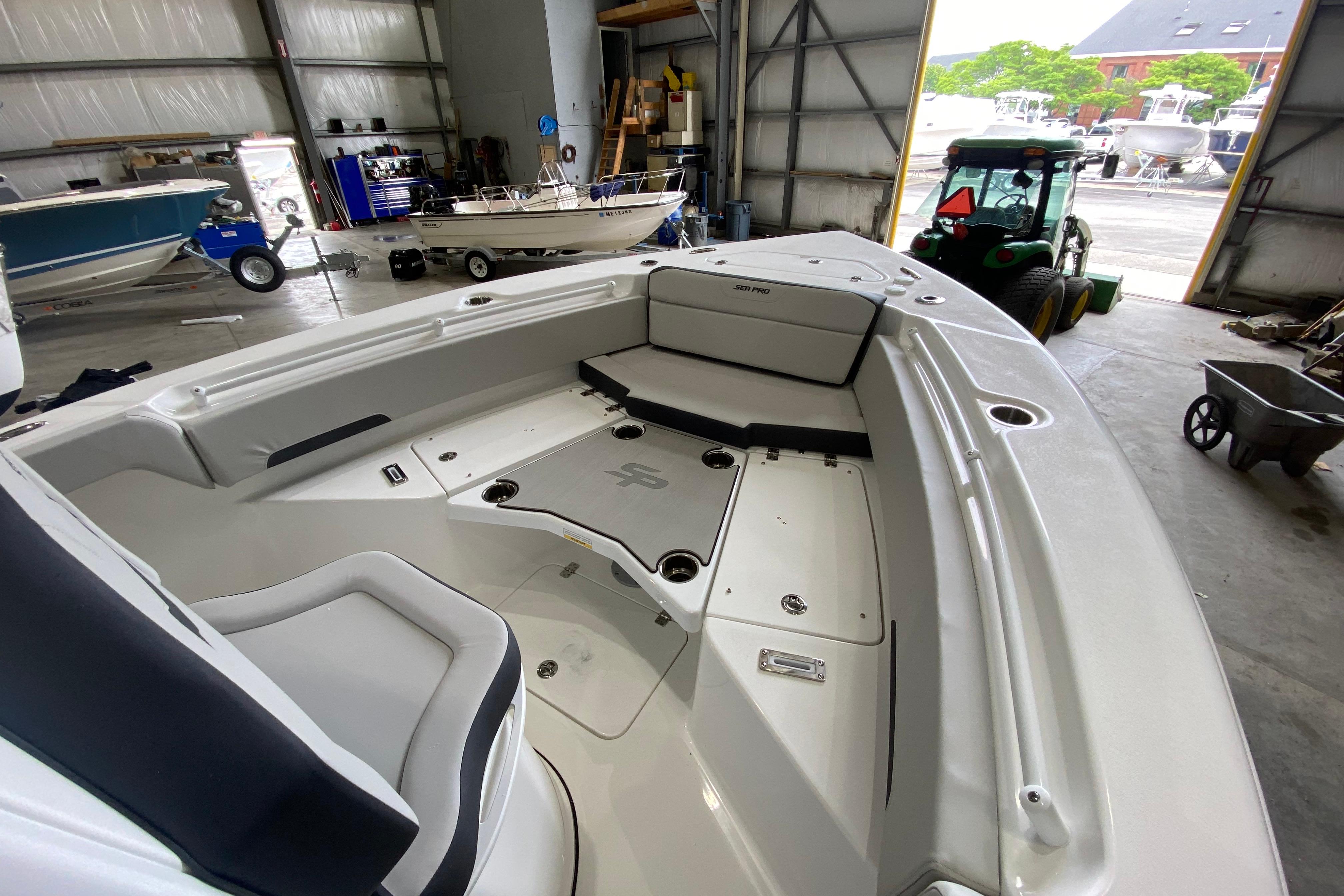 Interior view of 2027 Sea Pro 245FLXR Sandbar boat in a storage facility.