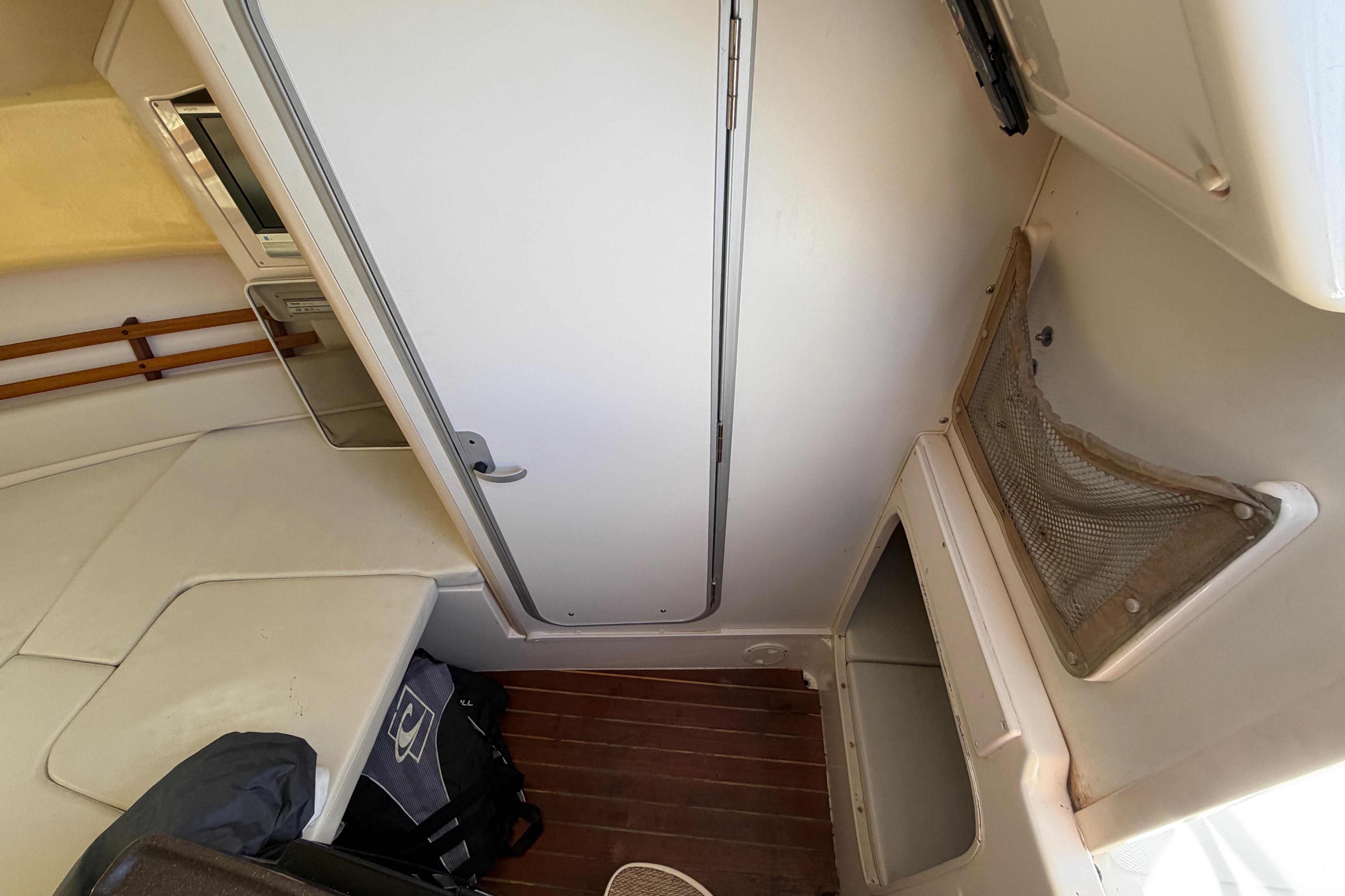 2006 Grady-White Sailfish 282 cabin interior with seating and storage compartments.