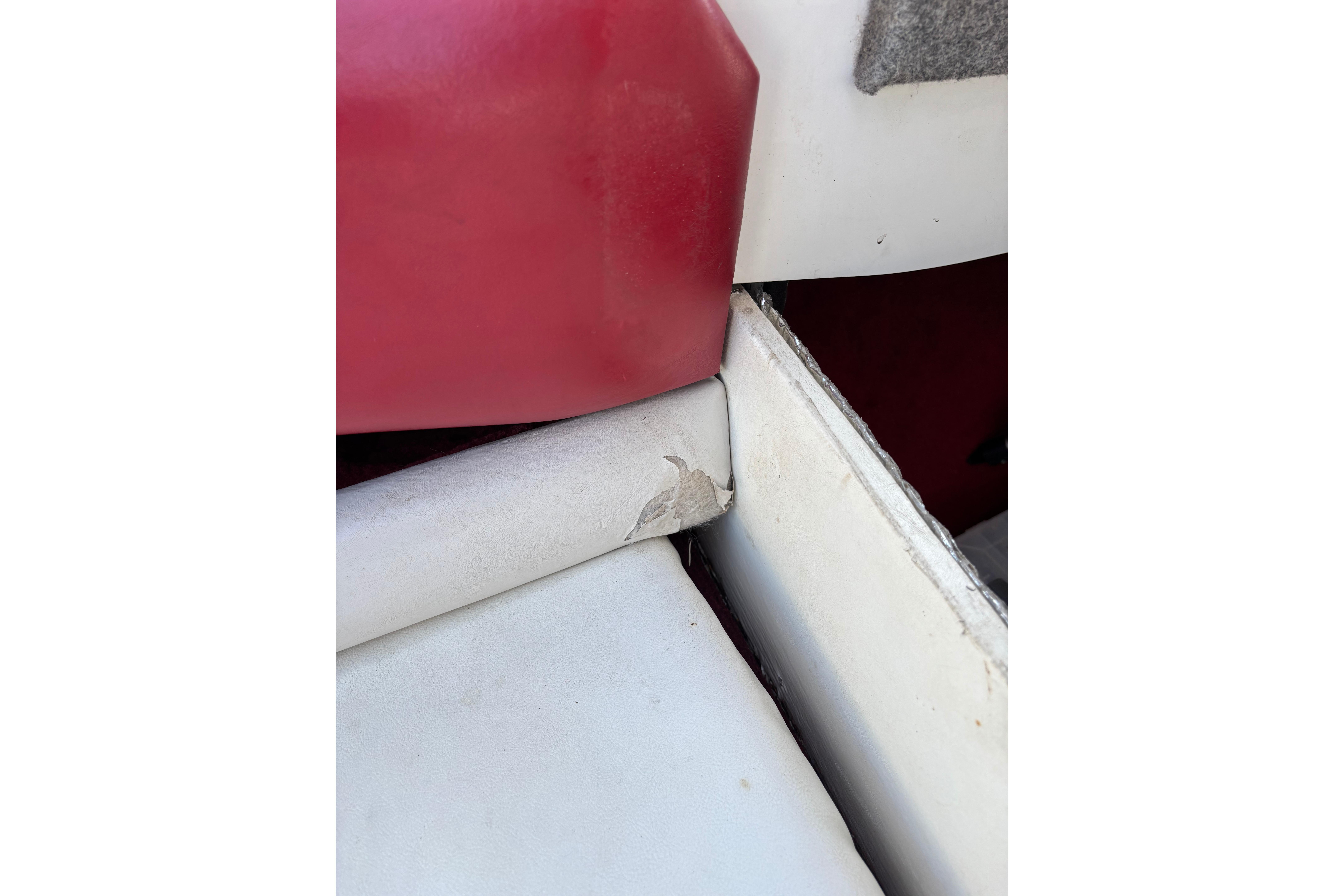 Interior detail of a 1993 Larson SEi 200 Cuddy I/O boat showing seat wear.