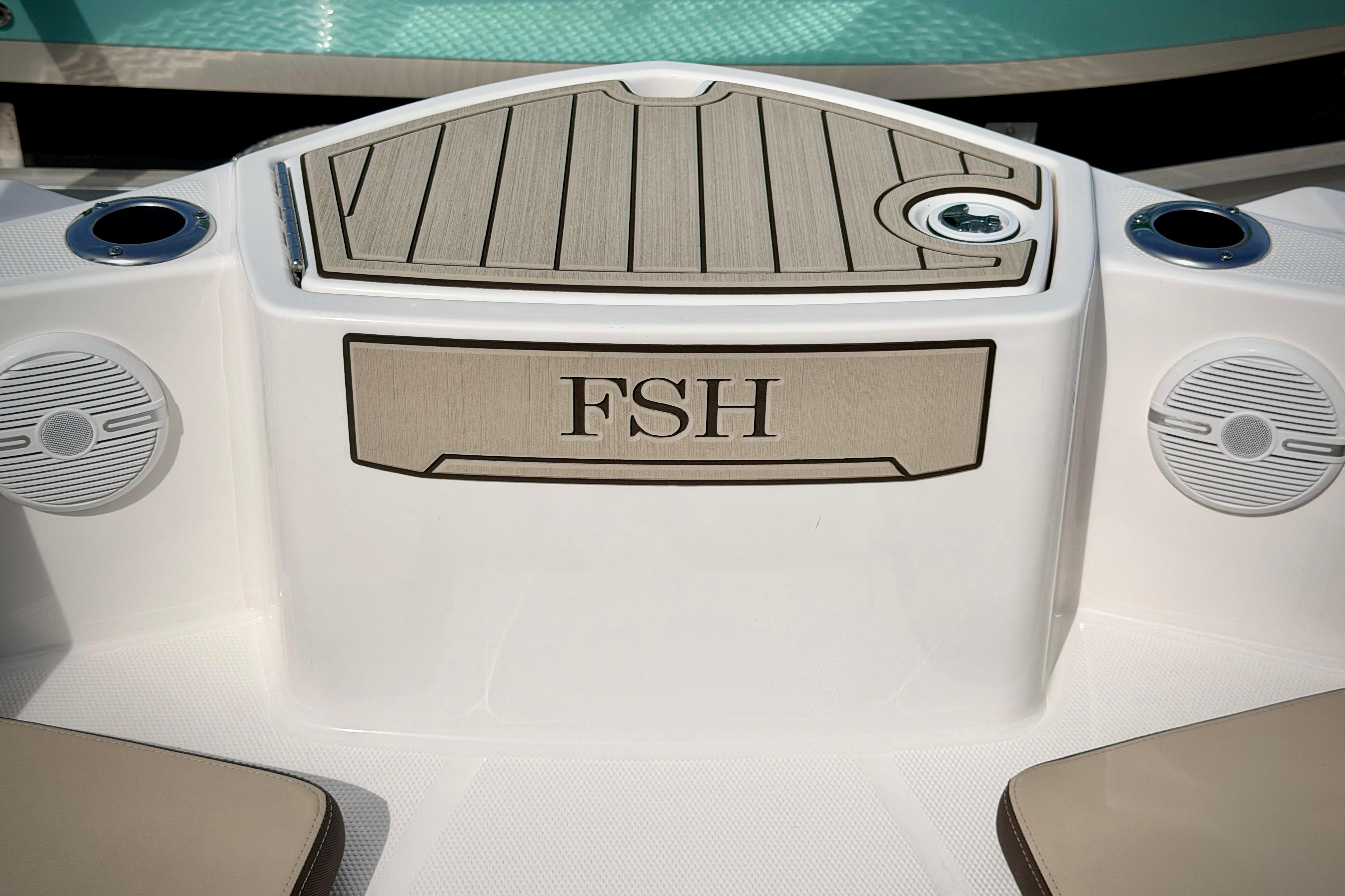 2025 Yamaha Boats 222 FSH Sport interior detail with speakers and storage compartment.