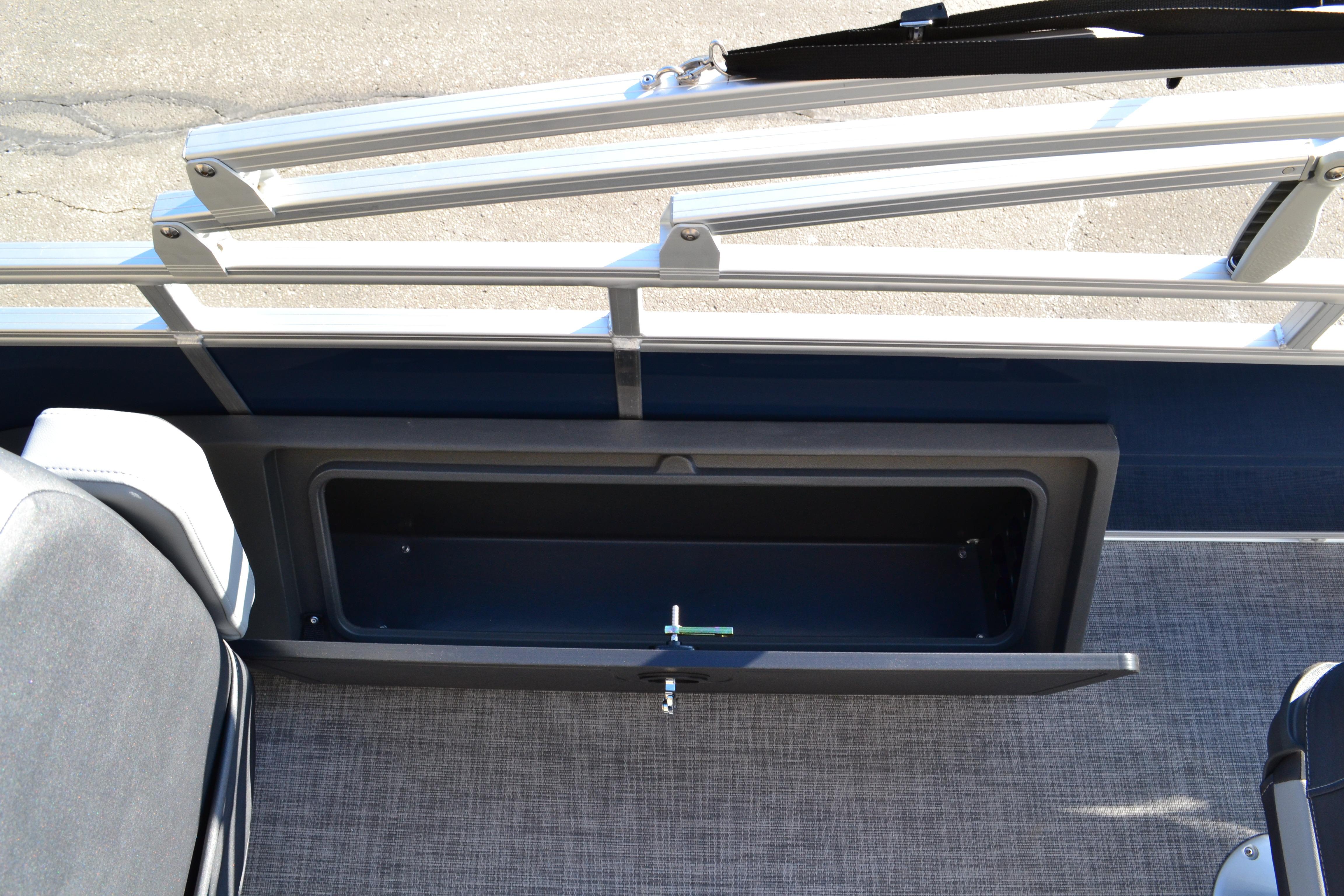 2026 Sun Tracker SportFish 22 XP3 boat storage compartment with open hatch, gray interior.