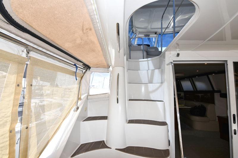 Interior view of 2008 Carver 43 Super Sport yacht with elegant staircase and modern design.