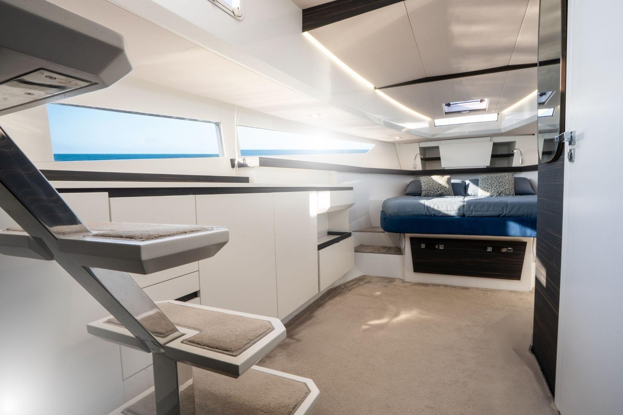 Luxurious interior of 2023 Fiart Seawalker 39 yacht with modern design and comfortable bedding.