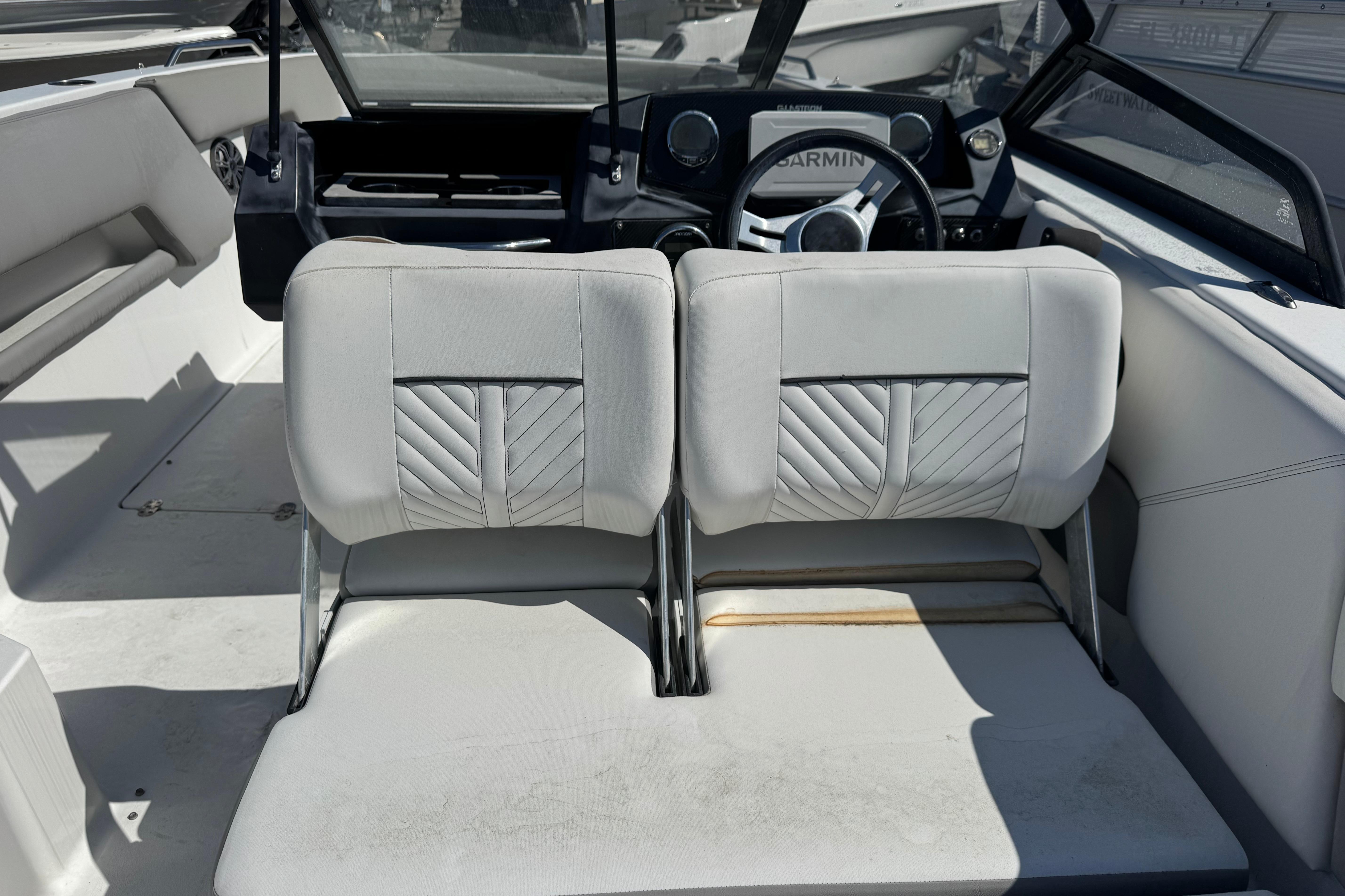 2020 Glastron GTD 240 boat interior with dual seats and steering wheel.