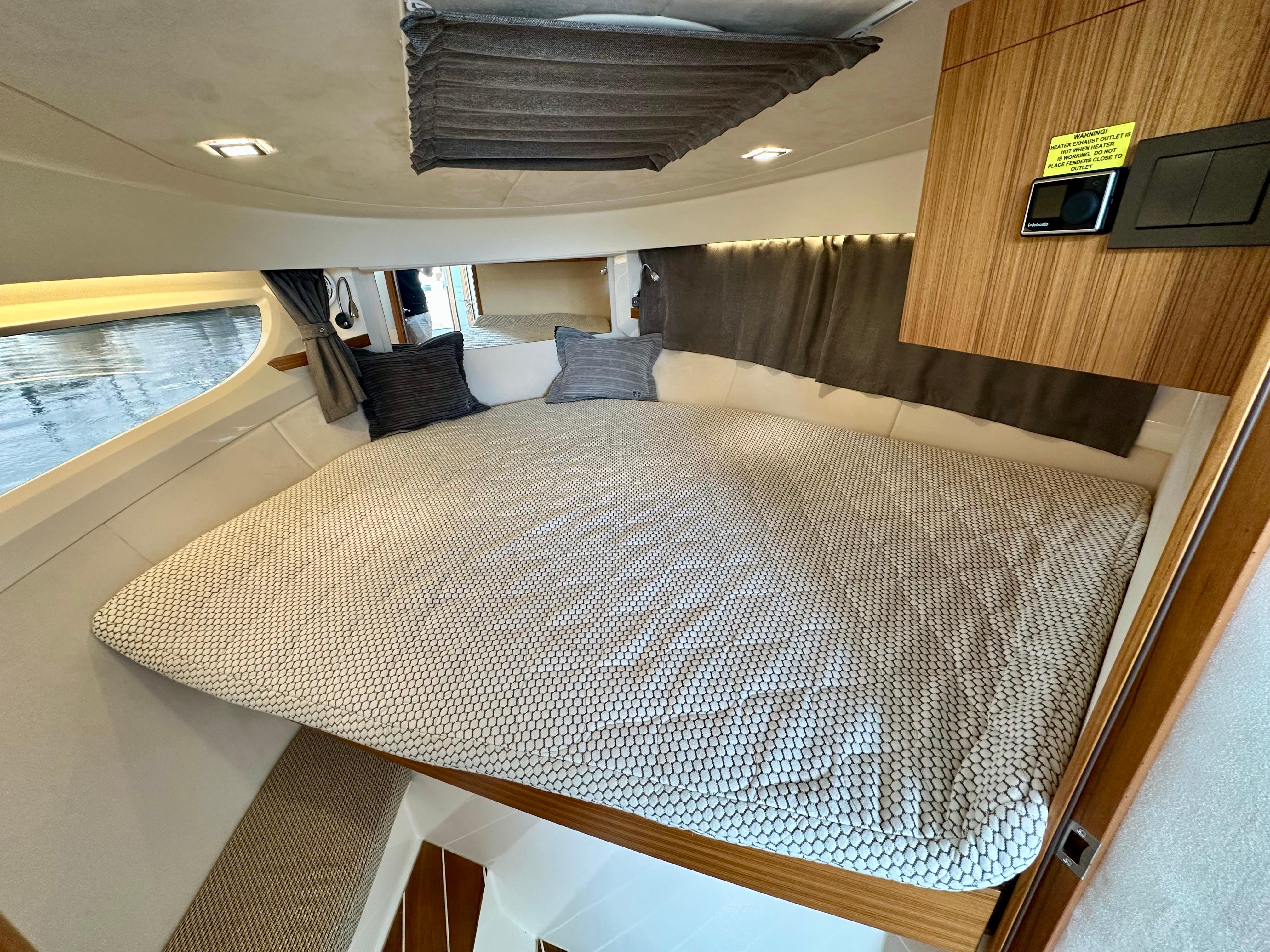 Interior of 2021 Marex 310 Sun Cruiser with cozy bed.