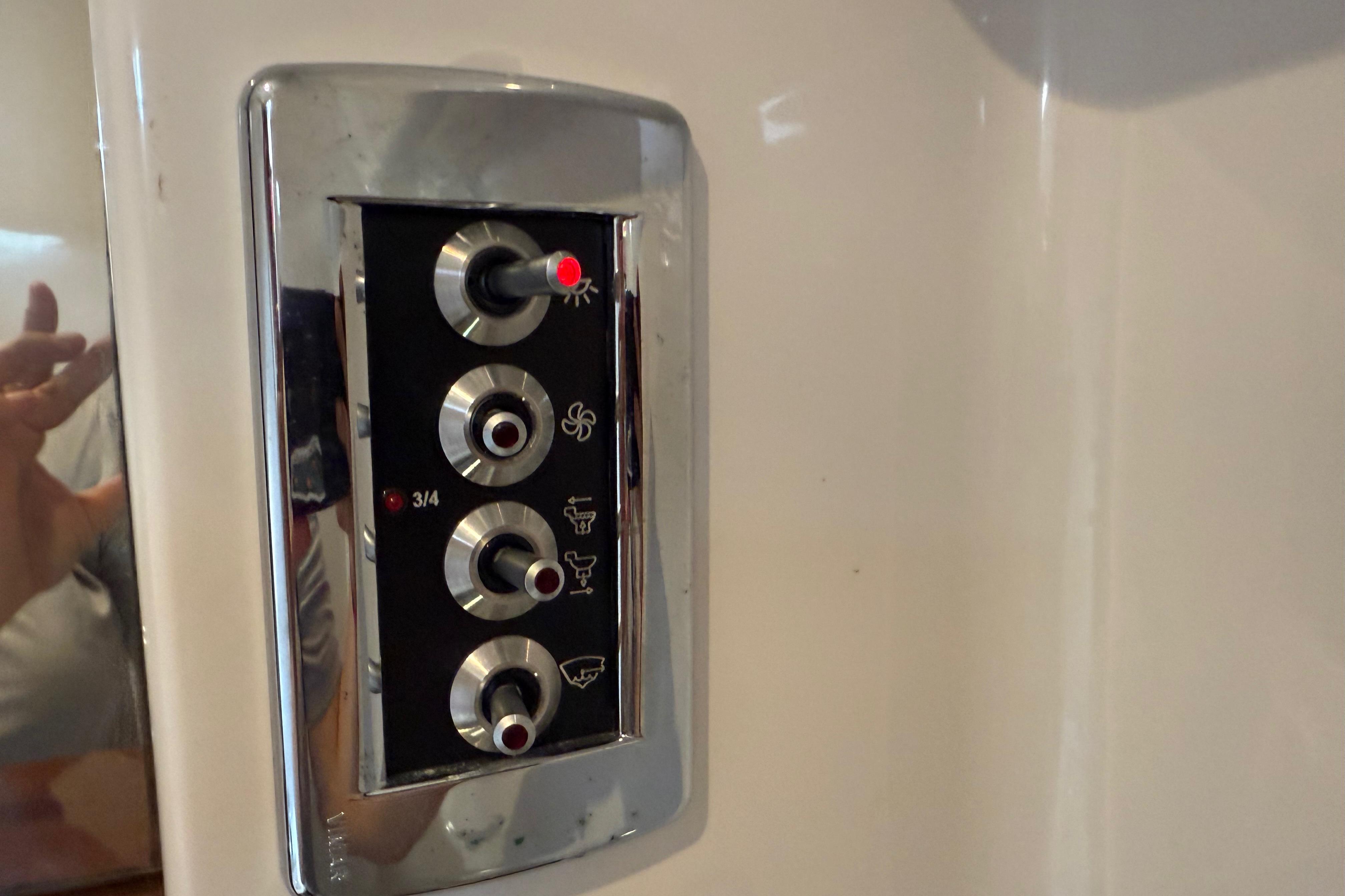 Control panel on a 2017 Four Winns V275 boat, featuring various switches.
