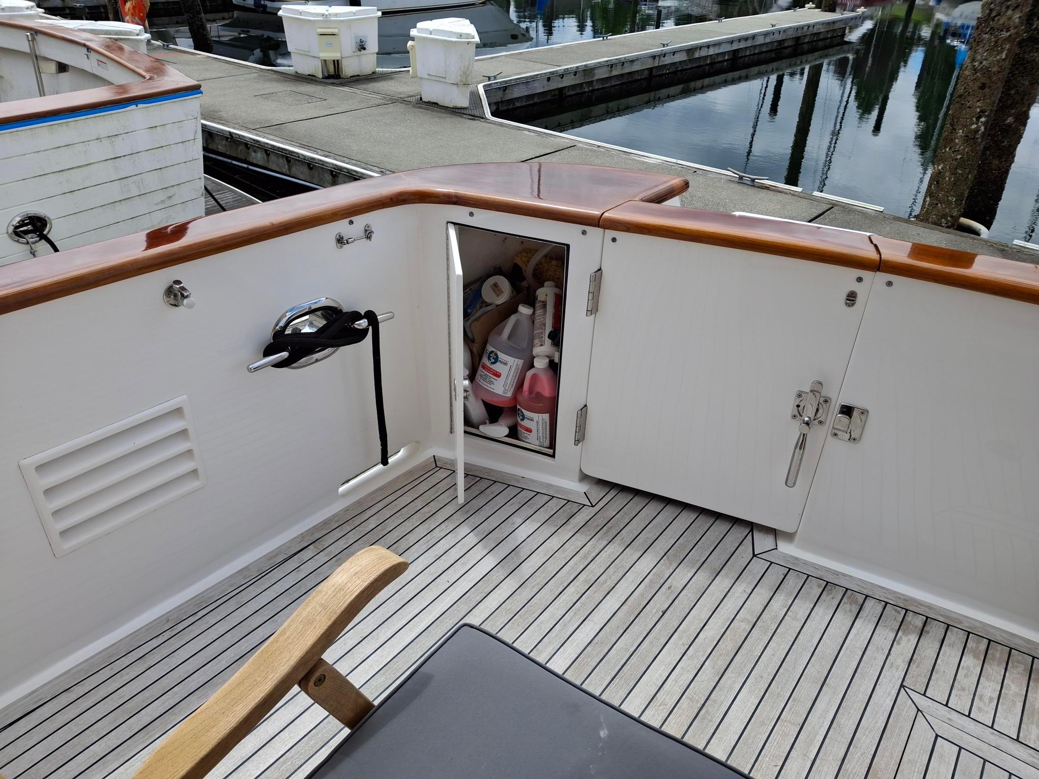 Deck view of 2004 Ocean Alexander 64 Pilothouse with open storage compartment.