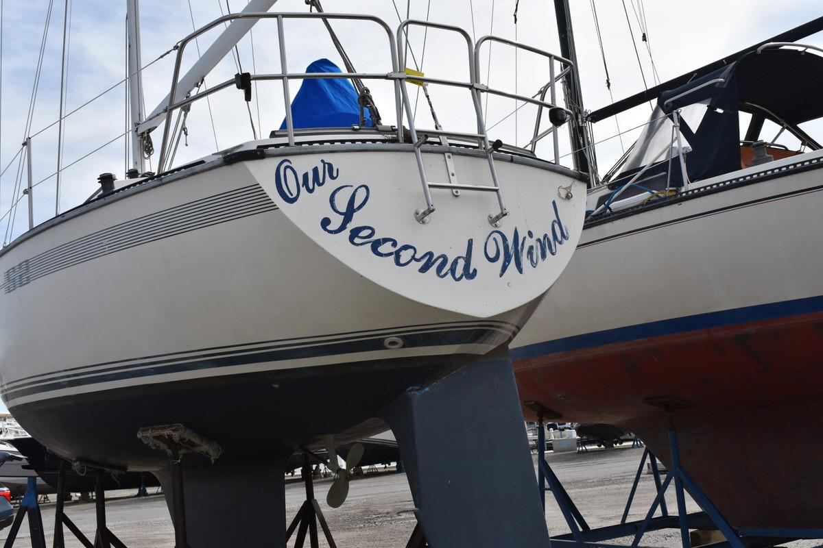 A 1987 S2 9.2A yacht on a stand, viewed from the stern.