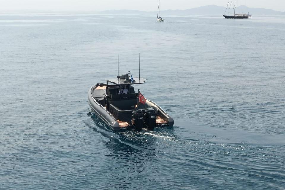 Novamarine Black Shiver 100, 2021 model, cruising on calm sea with distant sailboats.