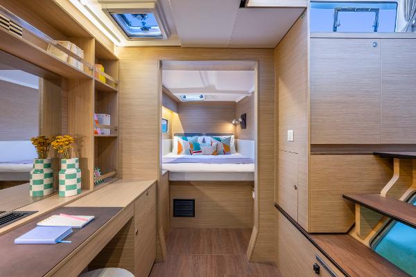 Luxurious interior of 2025 Lagoon 38 catamaran with modern design and cozy bedroom.