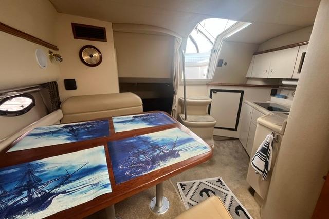 Interior of 2004 Cruisers Yachts 3372 Express with dining area and kitchenette.