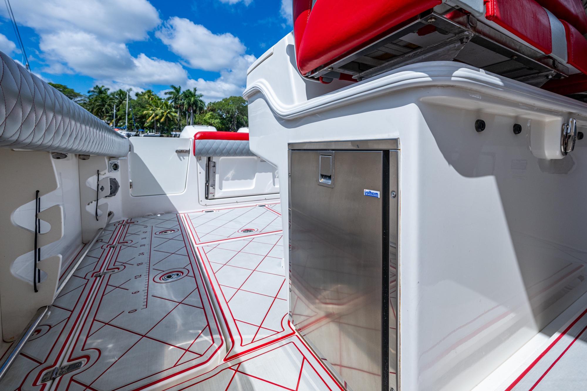 2018 Boston Whaler 330 boat interior with red seating and stainless steel storage.
