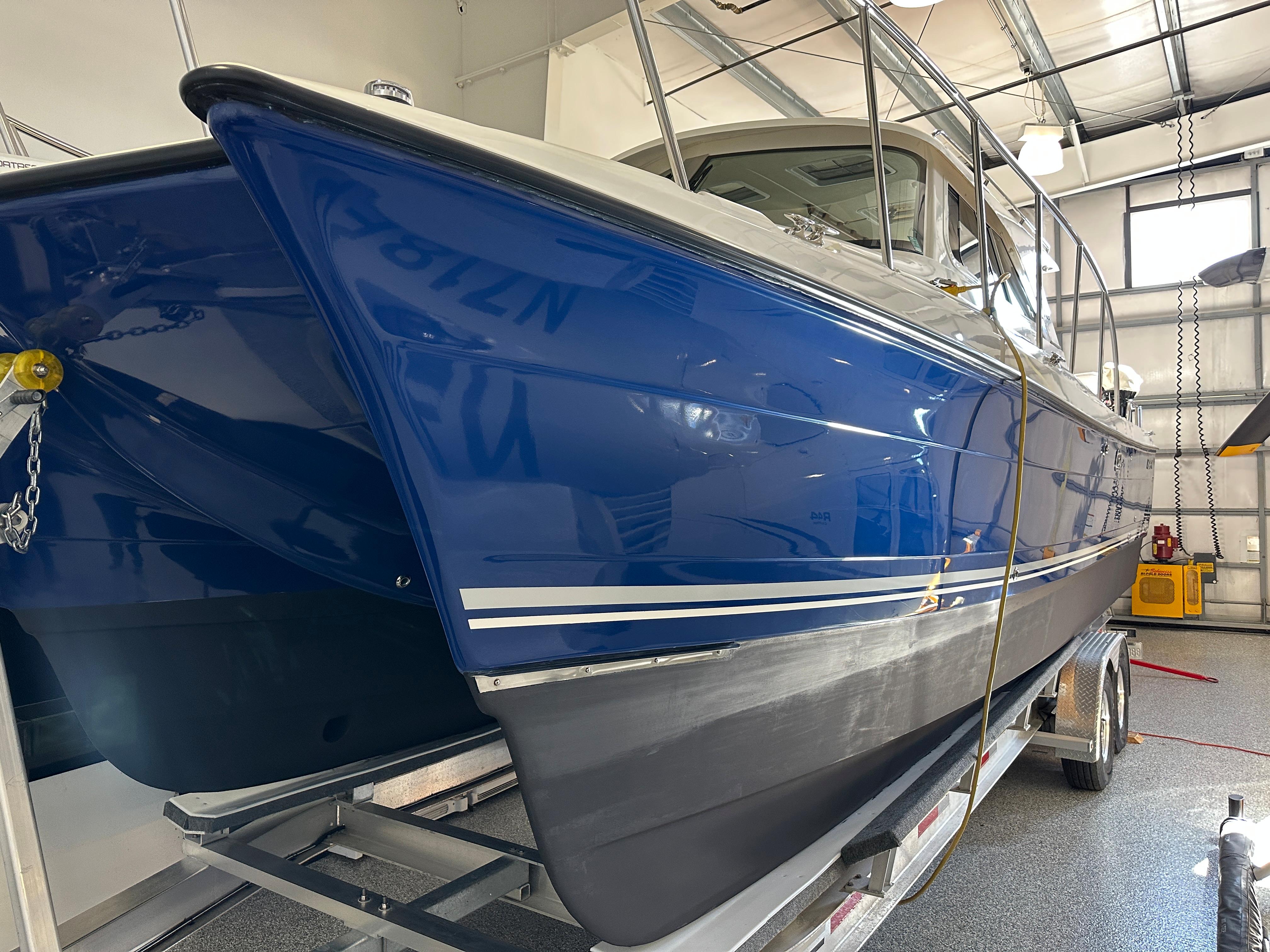 Blue 2016 Aspen C100 boat in a garage.