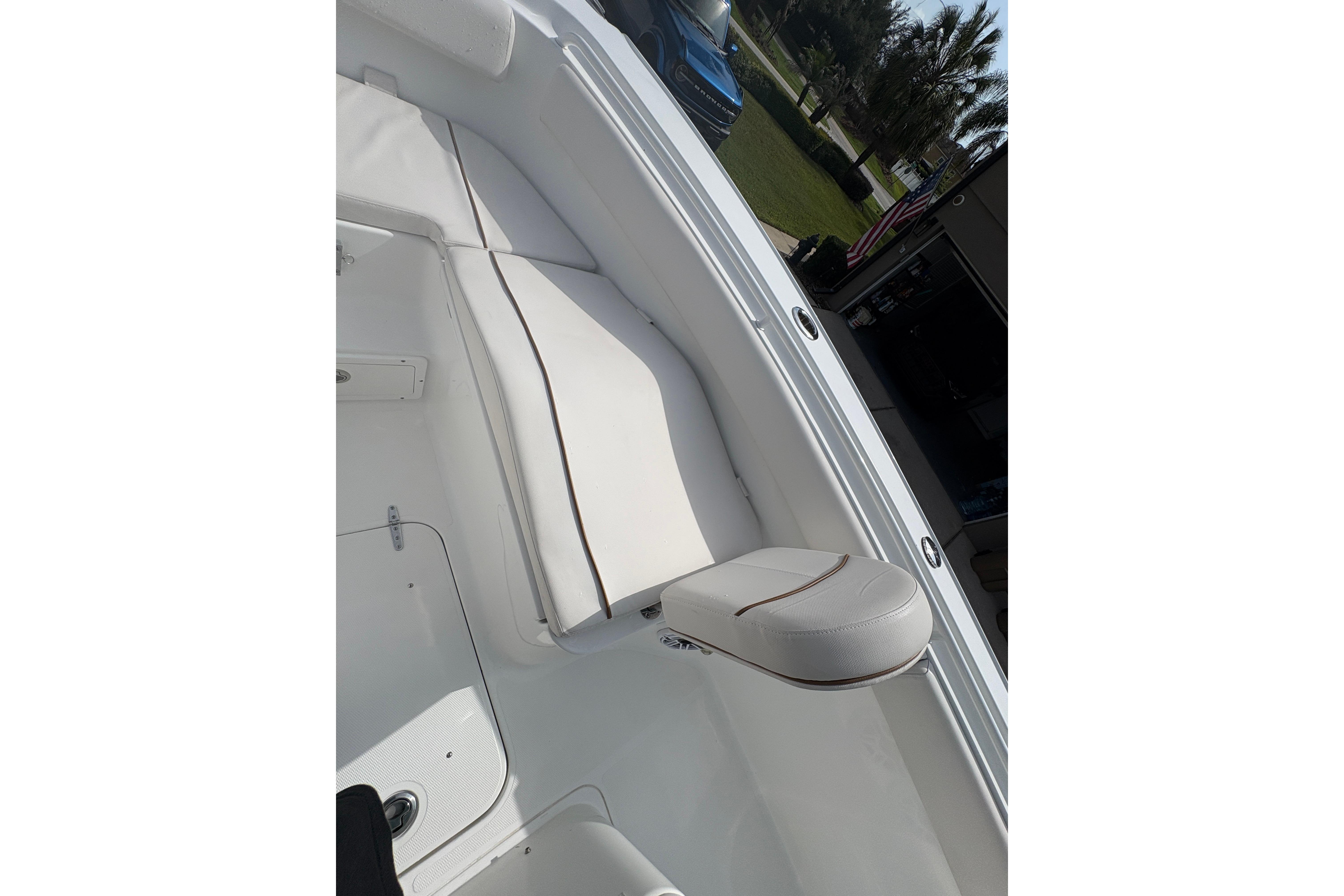 Interior view of 2021 Sea Hunt Ultra 265 SE boat, featuring white cushioned seating.