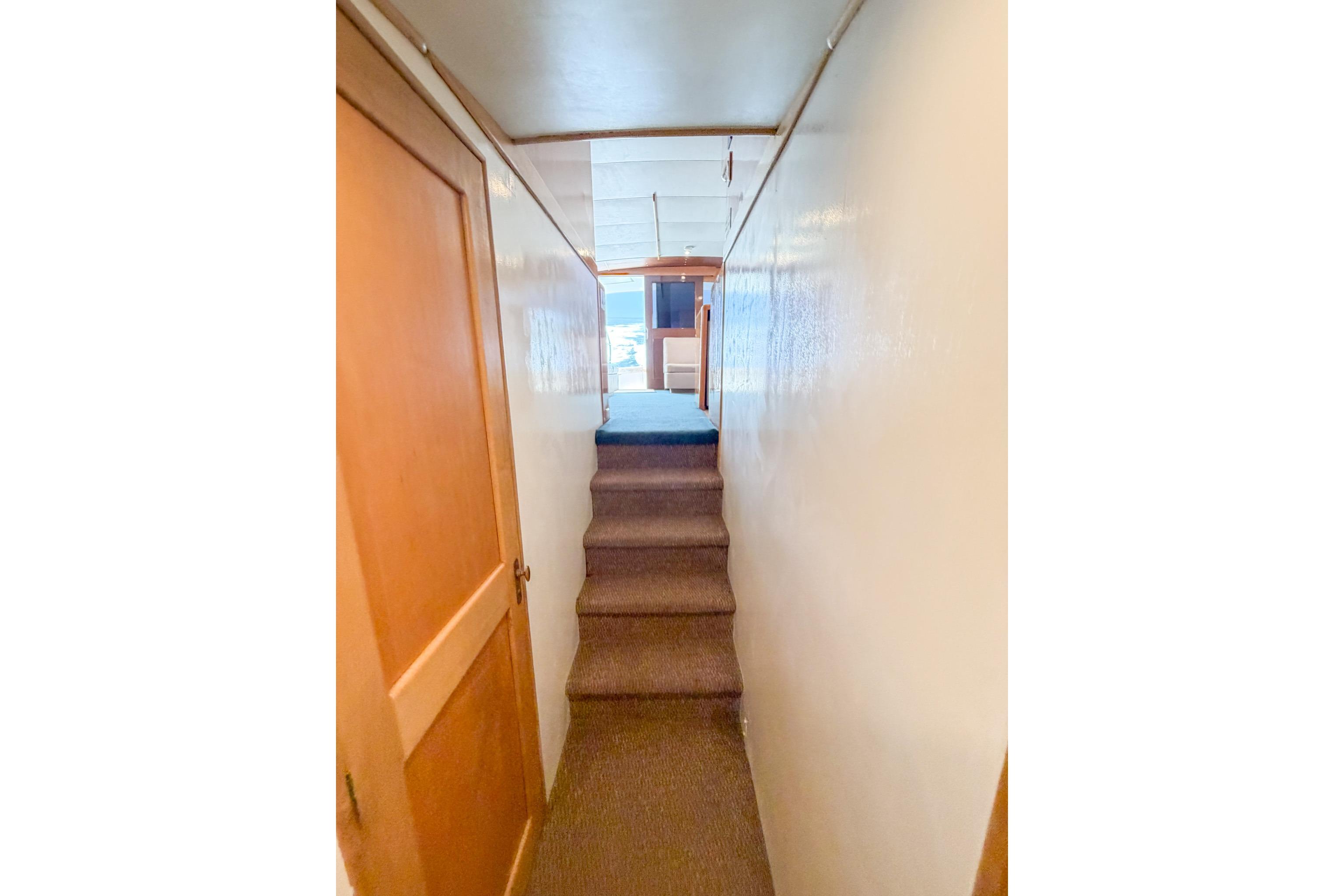 Interior hallway of 1998 Blackwell Custom Carolina Sportfish boat with carpeted stairs.