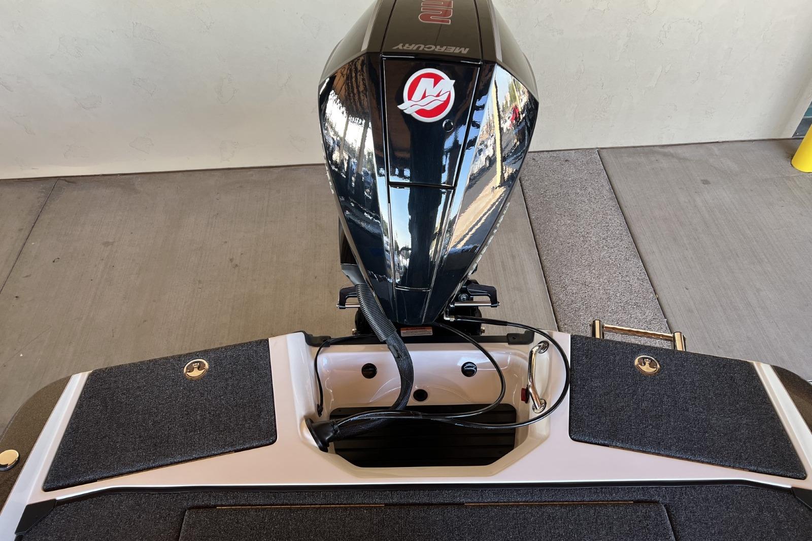 2025 Ranger 212LS boat with Mercury outboard motor, rear view on a concrete surface.
