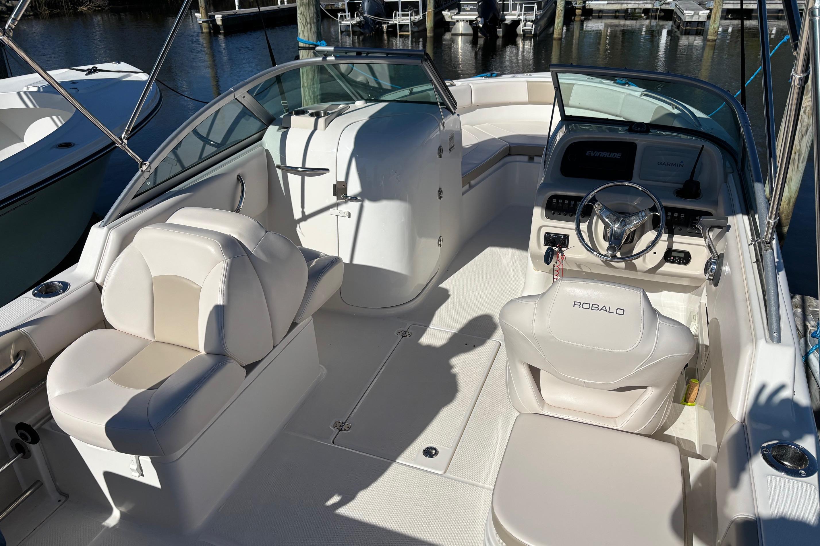 2017 Robalo R227 Dual Console boat interior with white seating and steering wheel.