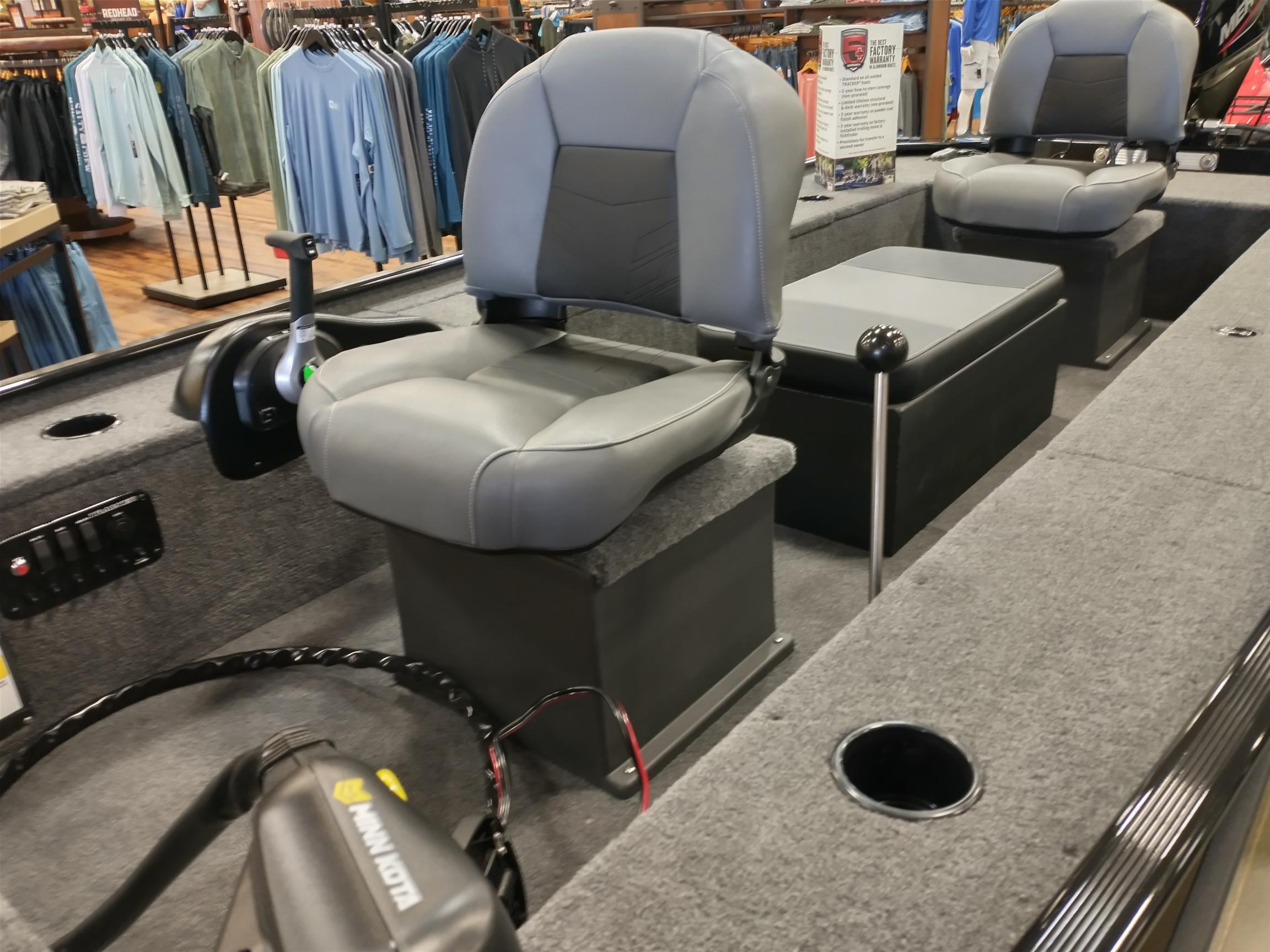 2025 Tracker Panfish 17 boat interior with gray seating and fishing equipment.