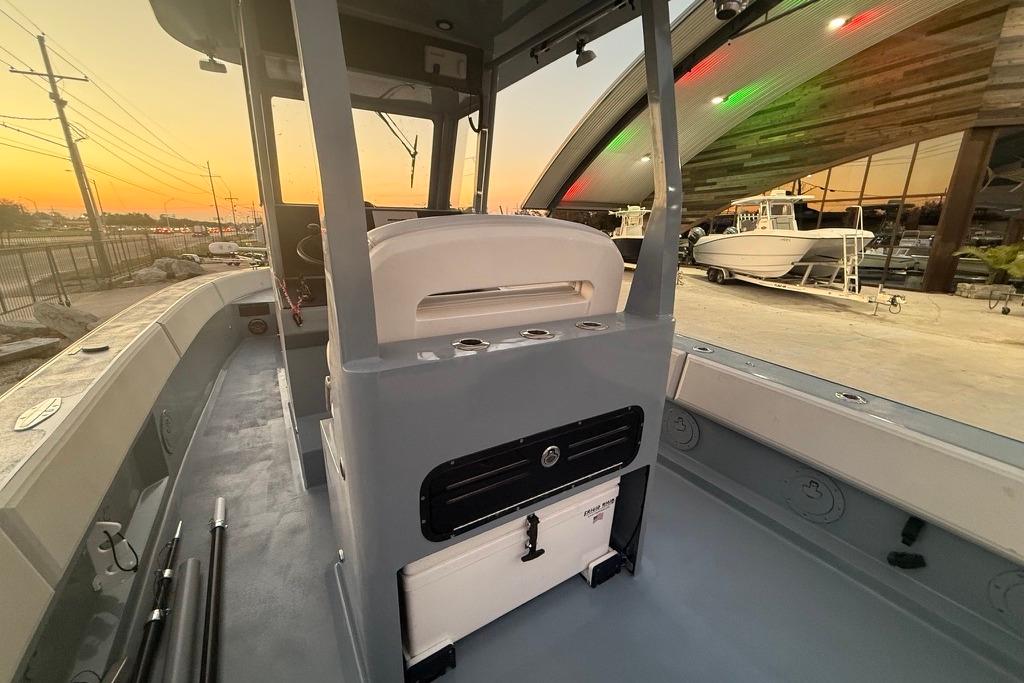 2019 Metal Shark 28 CC boat interior at sunset, showcasing helm and seating area.