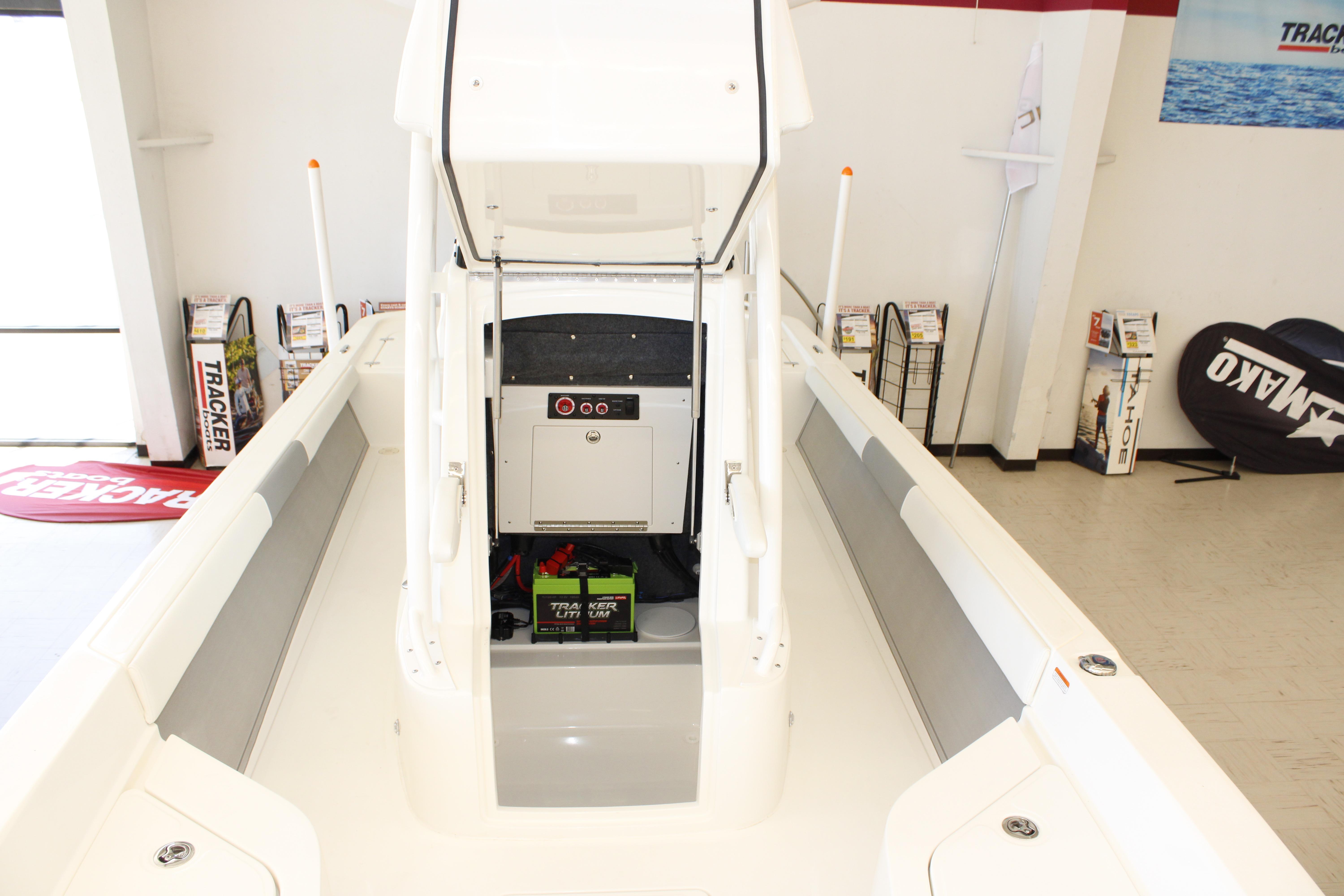 2026 Mako 24 APEX boat interior with storage compartment and Tracker lithium battery.